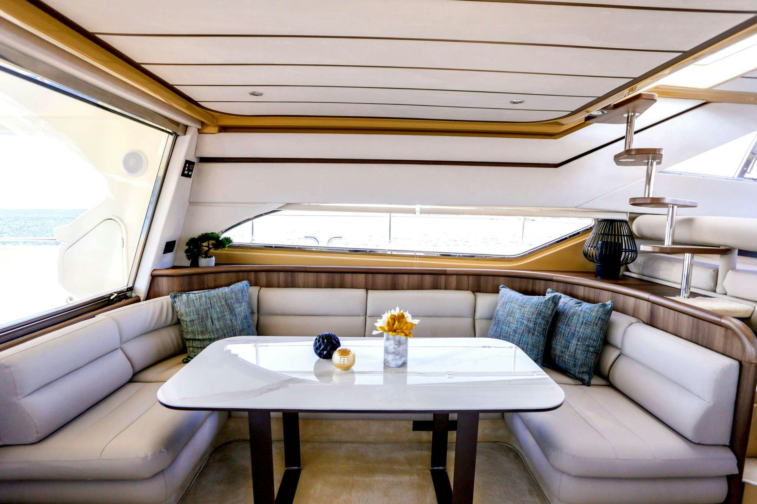 a room with a couch and a table with a glass coffee table aboard SUMMER CAMP Yacht for Charter