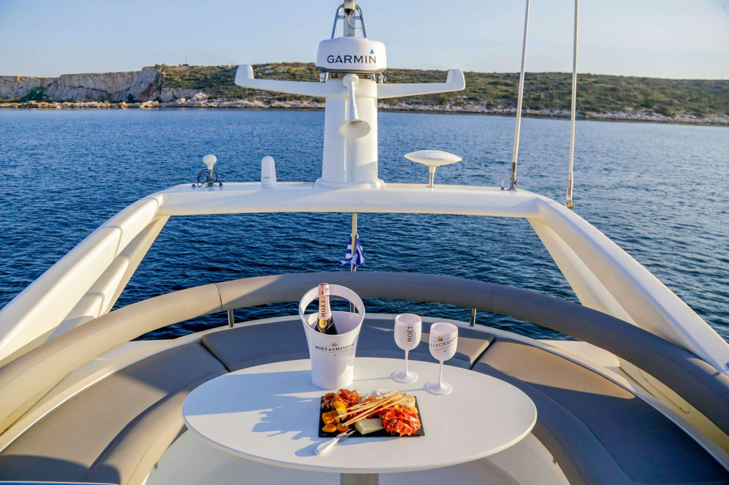 a boat with a table and wine glasses on it aboard SUMMER CAMP Yacht for Charter