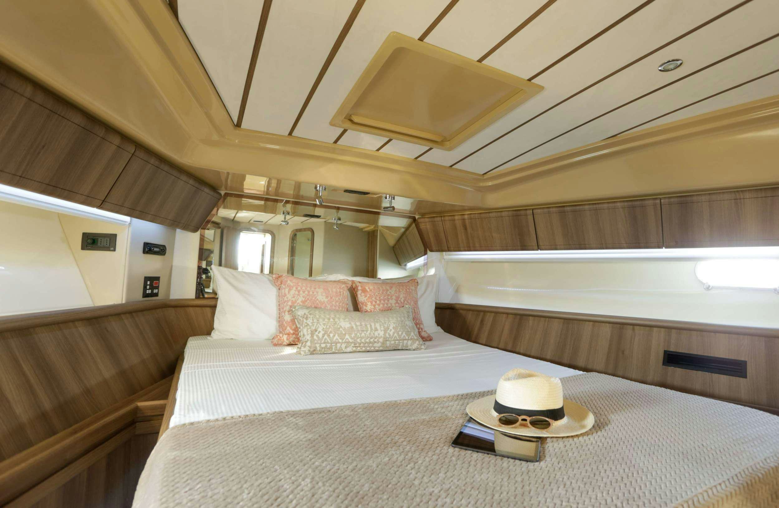 a bed with a white bed spread aboard SUMMER CAMP Yacht for Charter
