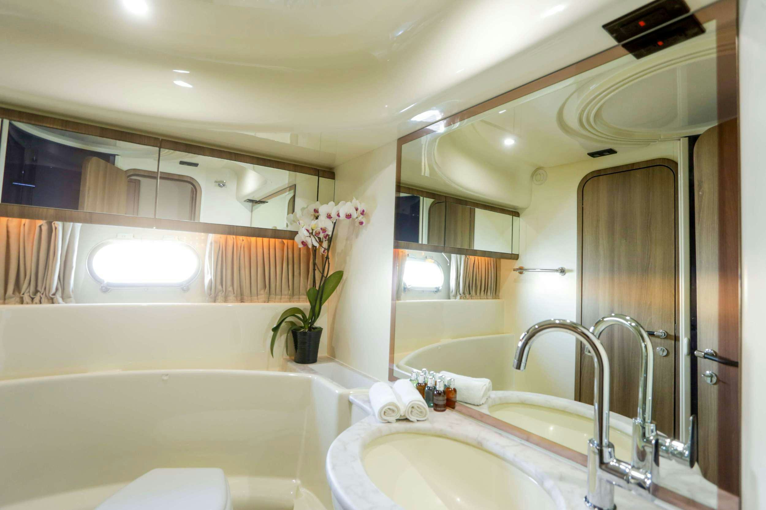 a bathroom with a large mirror aboard SUMMER CAMP Yacht for Charter