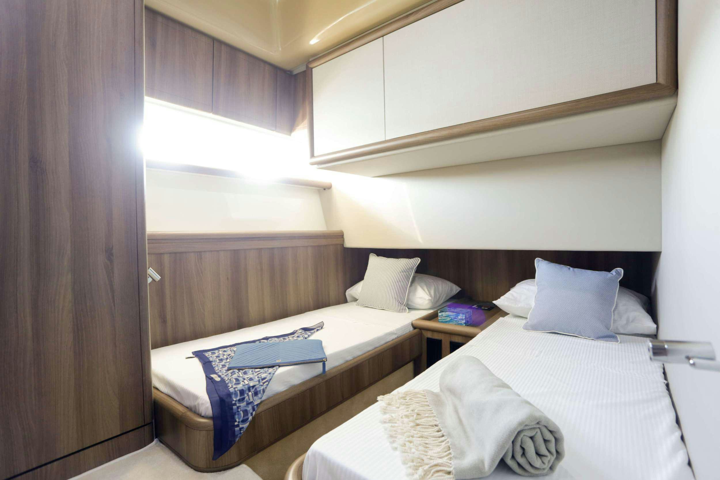 a couple of beds in a hotel room aboard SUMMER CAMP Yacht for Charter