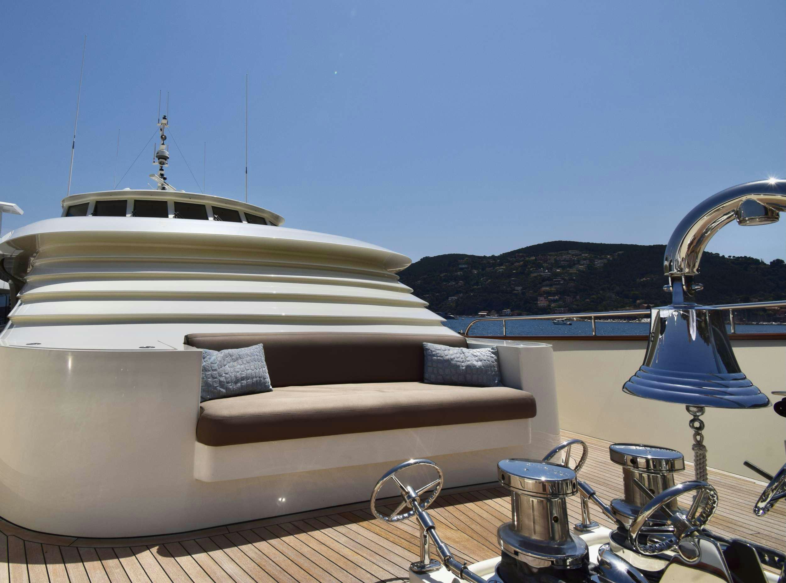 a white couch with a lamp on it aboard ORIZZONTE Yacht for Charter