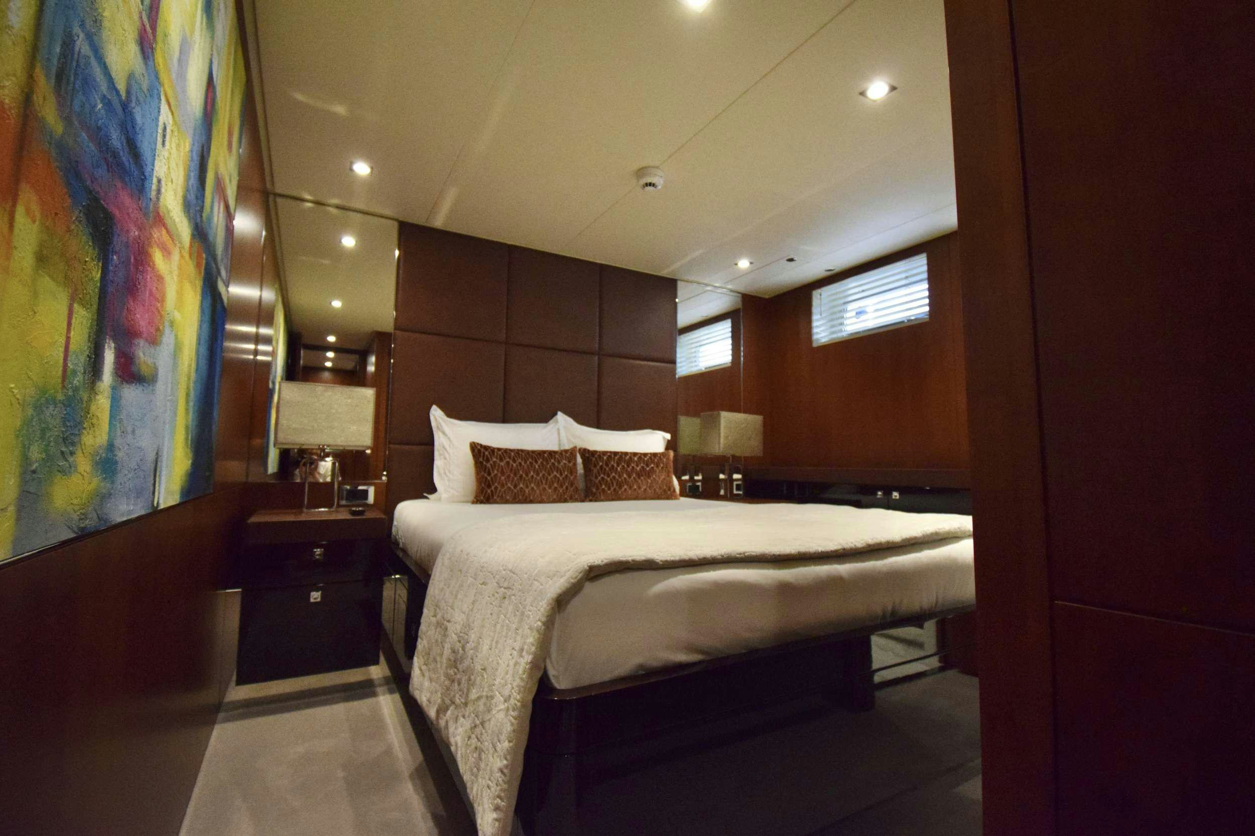 a bedroom with a large bed aboard ORIZZONTE Yacht for Charter