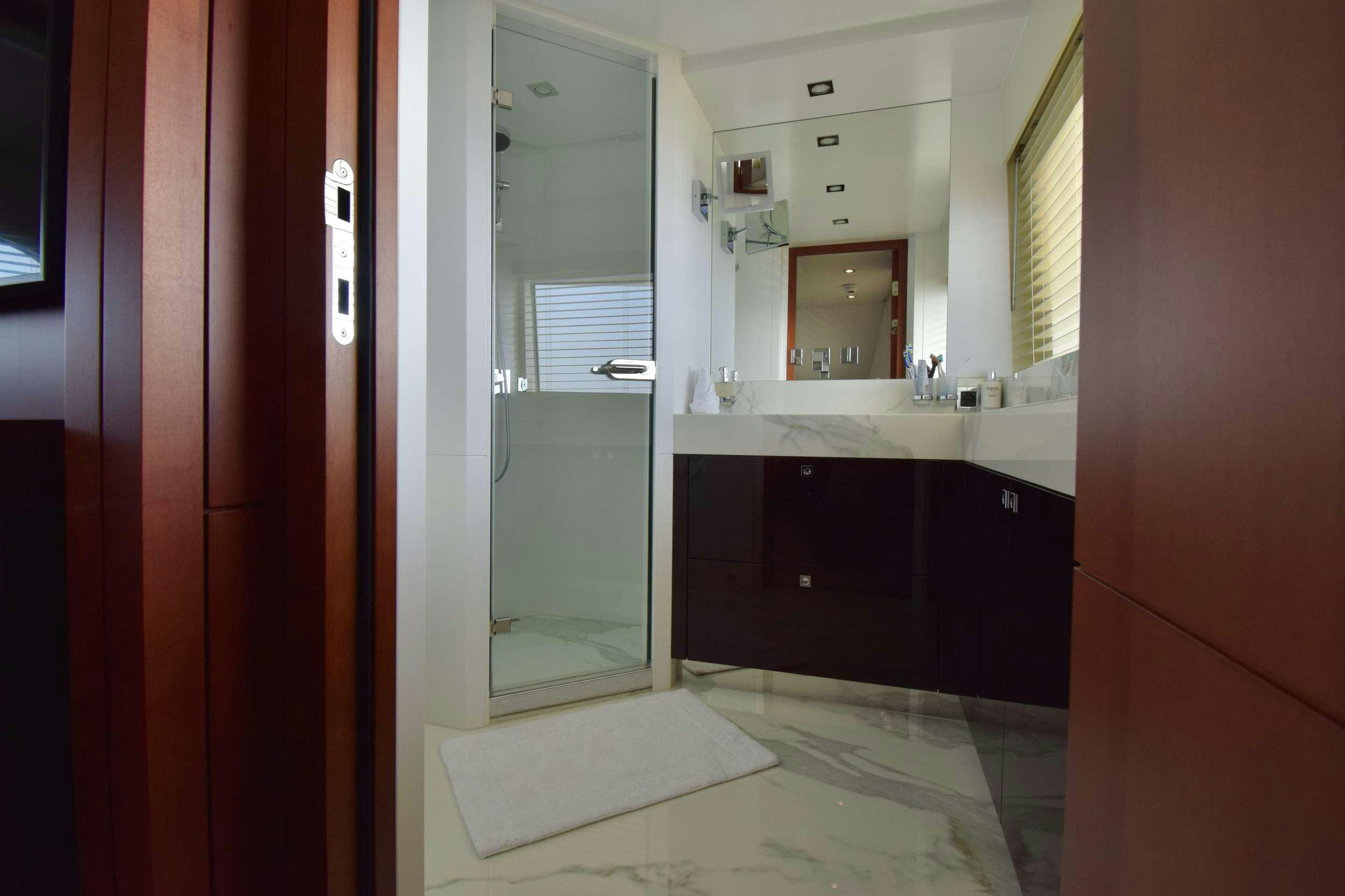 a bathroom with a sink and a mirror aboard ORIZZONTE Yacht for Charter