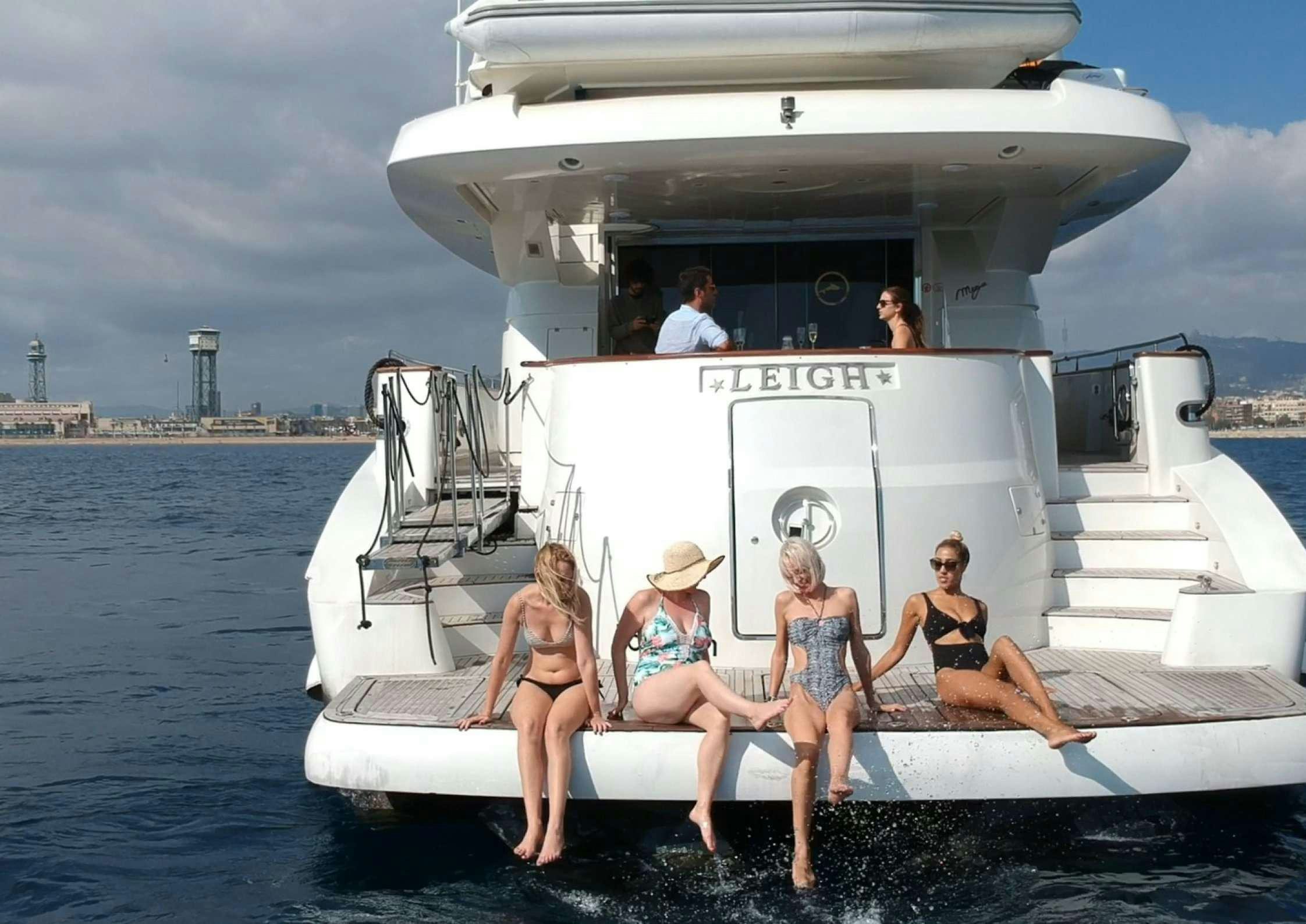 a group of people sitting on a boat in the water aboard LEIGH Yacht for Charter
