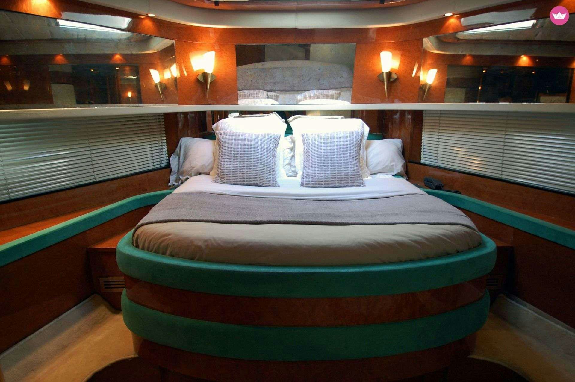 a bed with a blue comforter aboard LEIGH Yacht for Charter