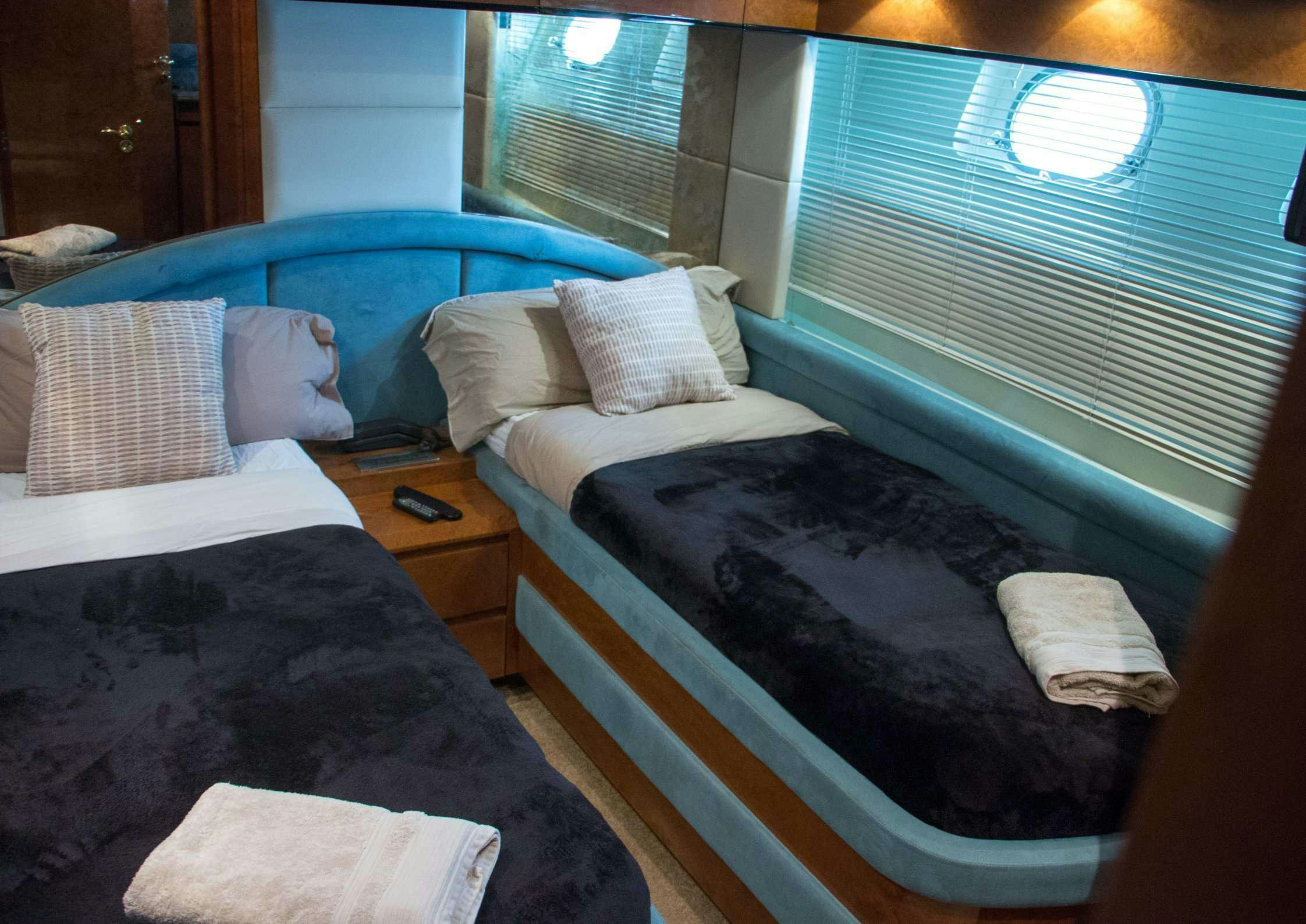 a couple of beds in a room aboard LEIGH Yacht for Charter