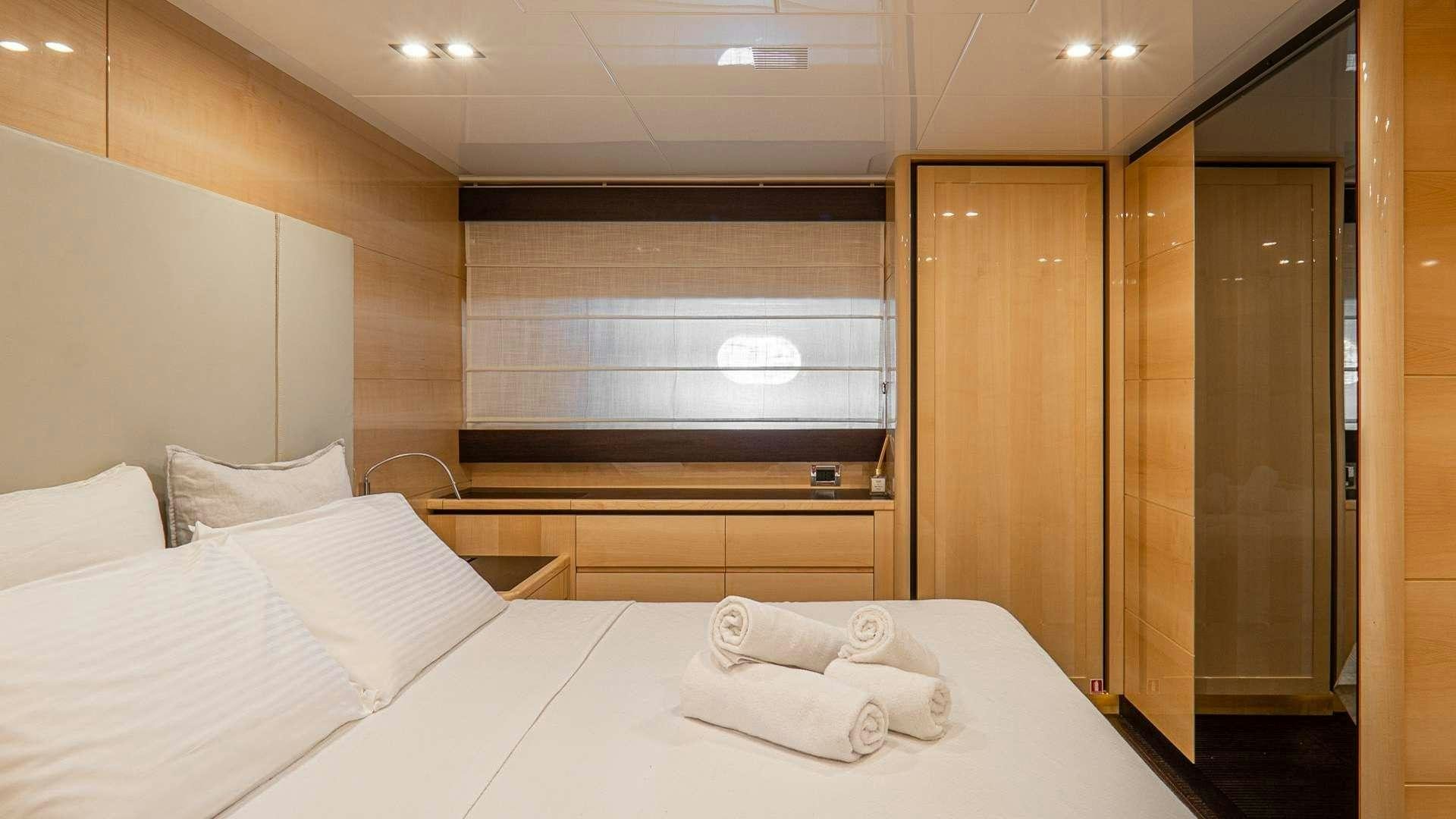 a room with a bed and a window aboard LIBERATA Yacht for Charter