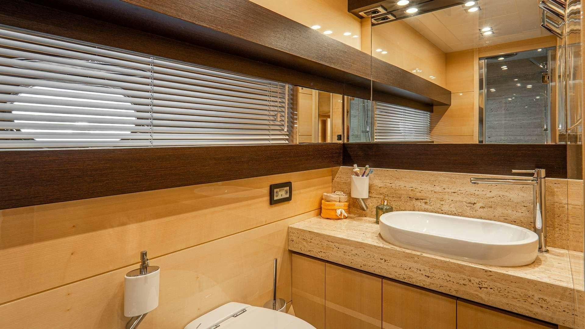 a bathroom with a sink and a mirror aboard LIBERATA Yacht for Charter
