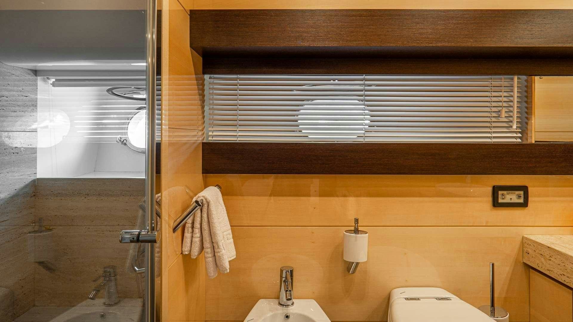 a bathroom with a sink and a toilet aboard LIBERATA Yacht for Charter