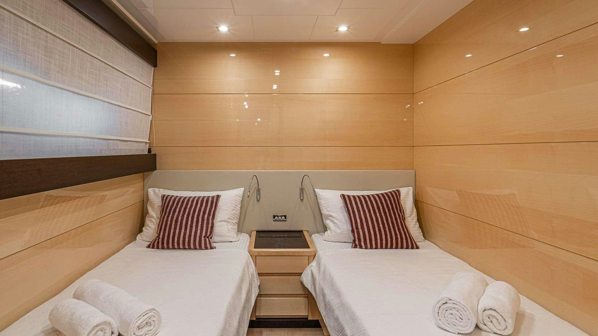 a room with two beds aboard LIBERATA Yacht for Charter