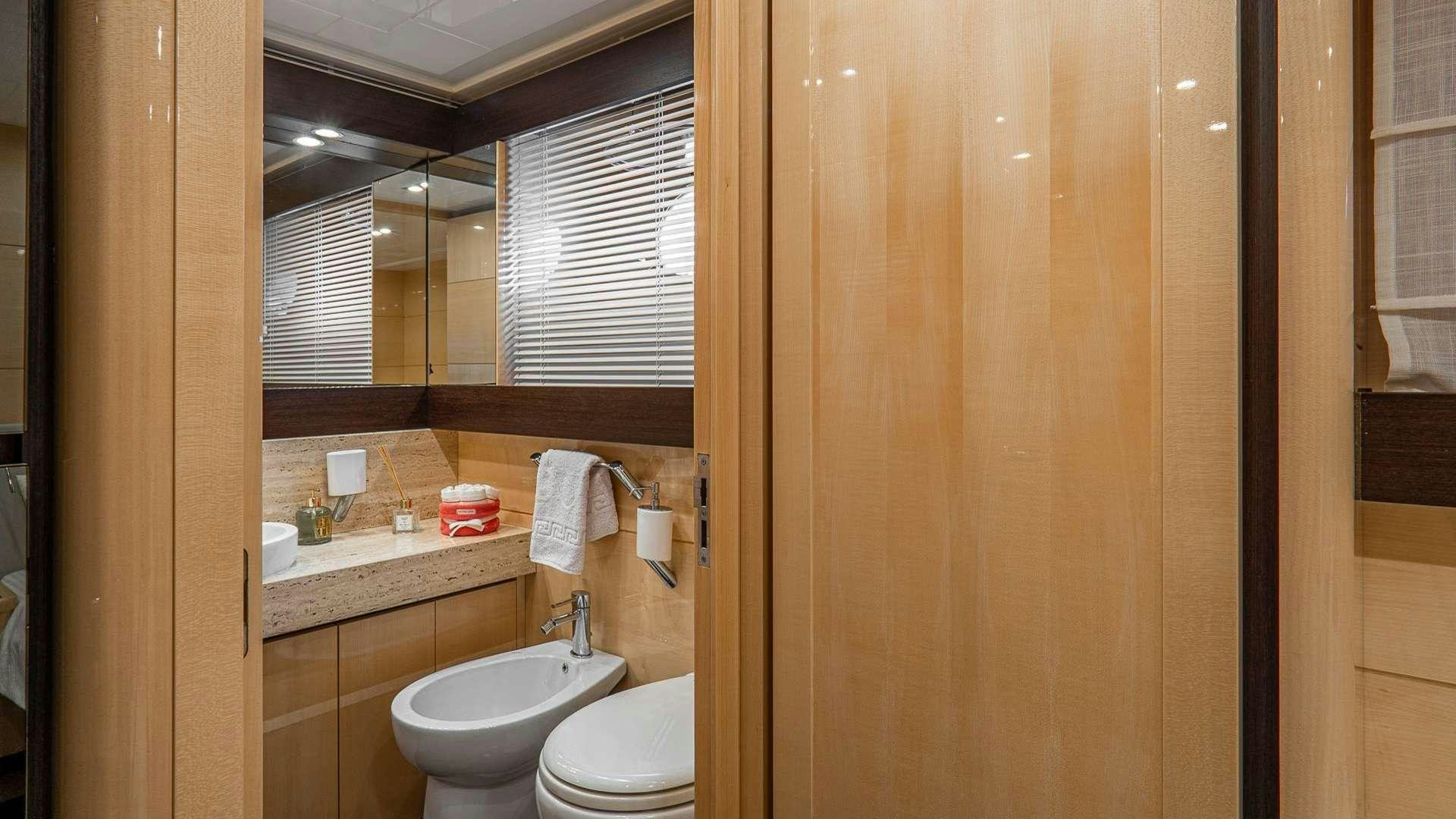 a bathroom with a sink and a mirror aboard LIBERATA Yacht for Charter