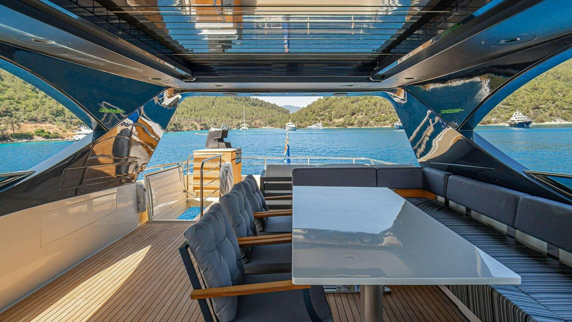 a boat with a deck and a view of the water aboard LIBERATA Yacht for Charter