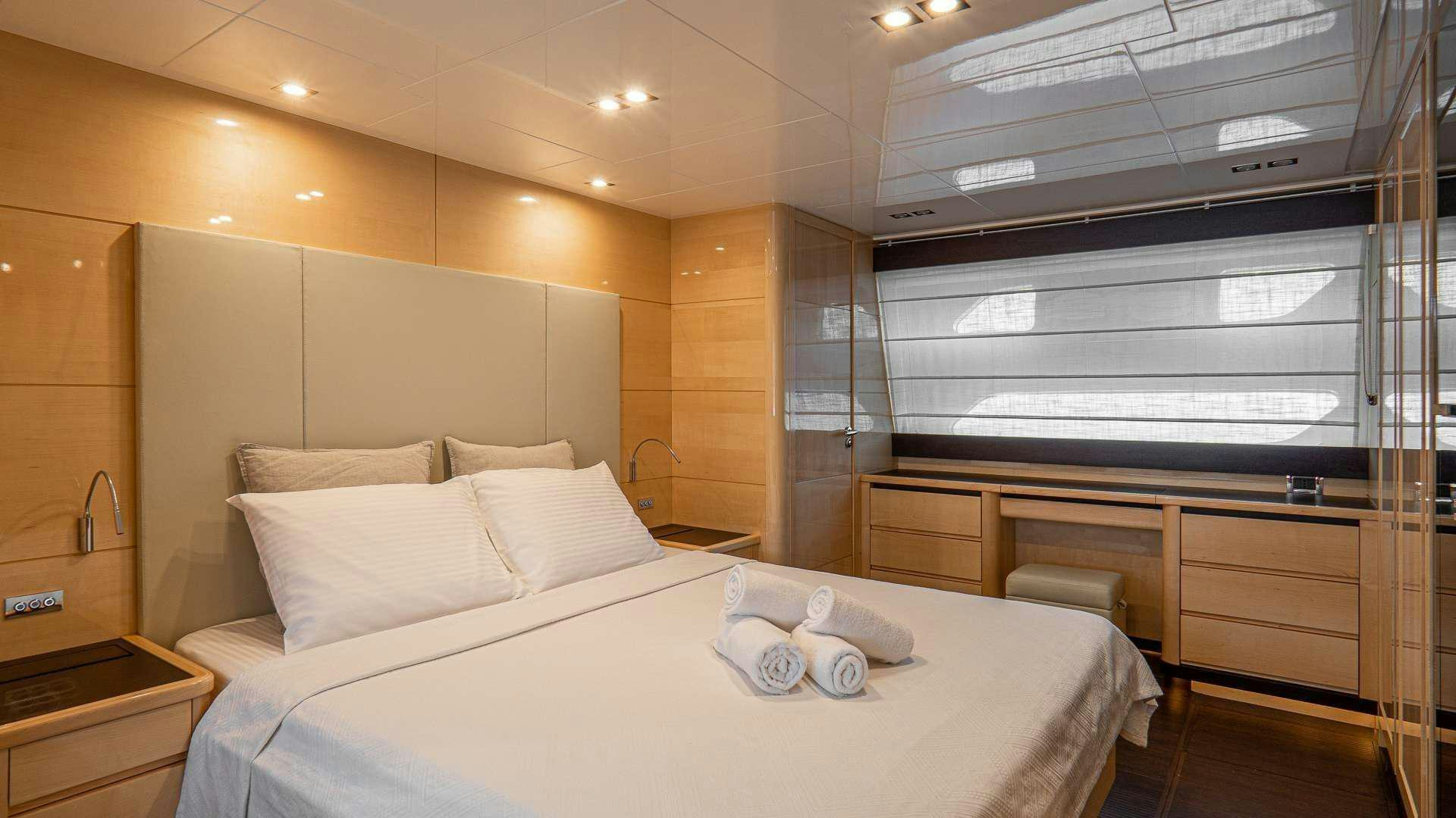 a room with a bed and a window aboard LIBERATA Yacht for Charter