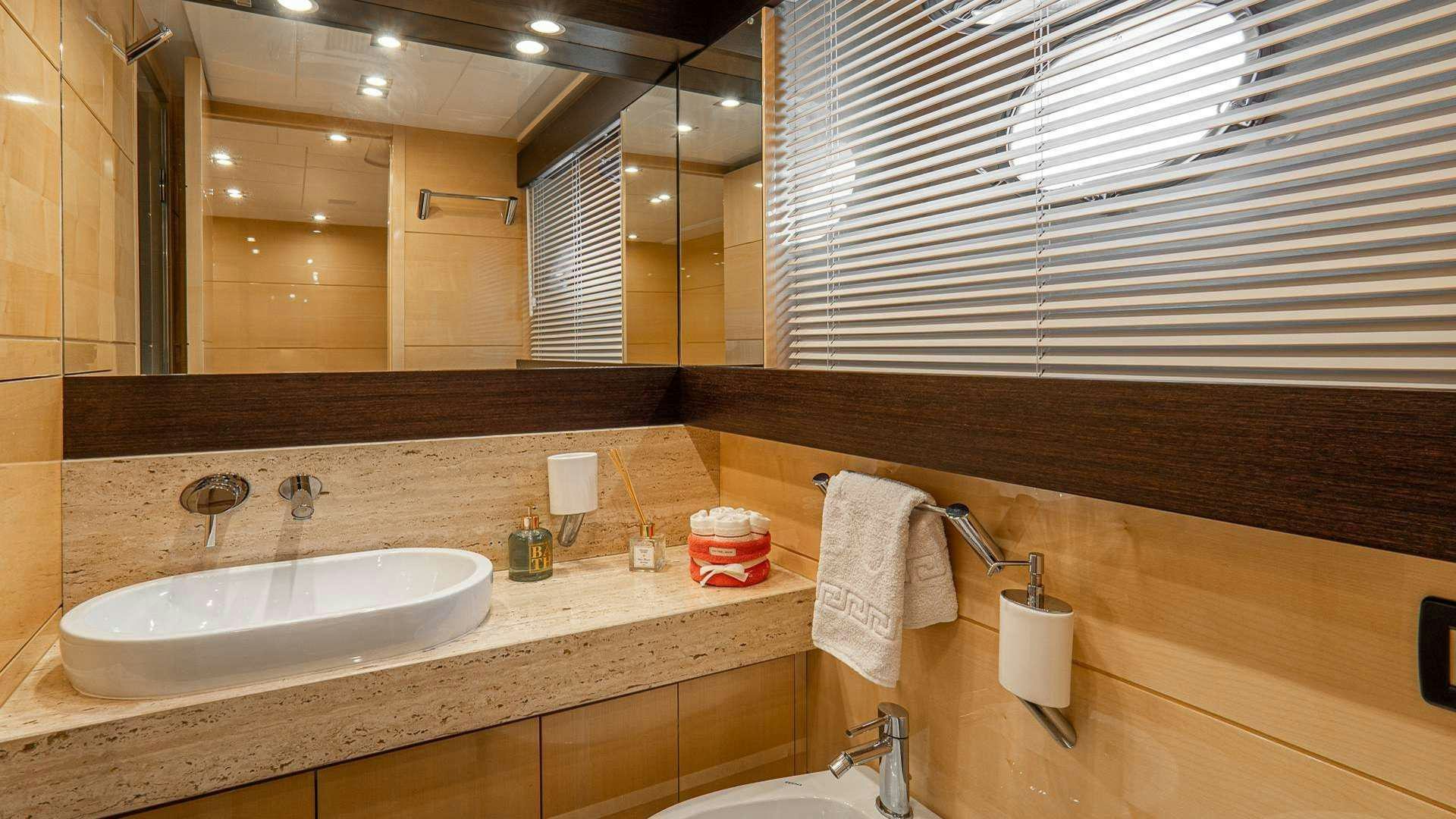 a bathroom with a sink and a mirror aboard LIBERATA Yacht for Charter