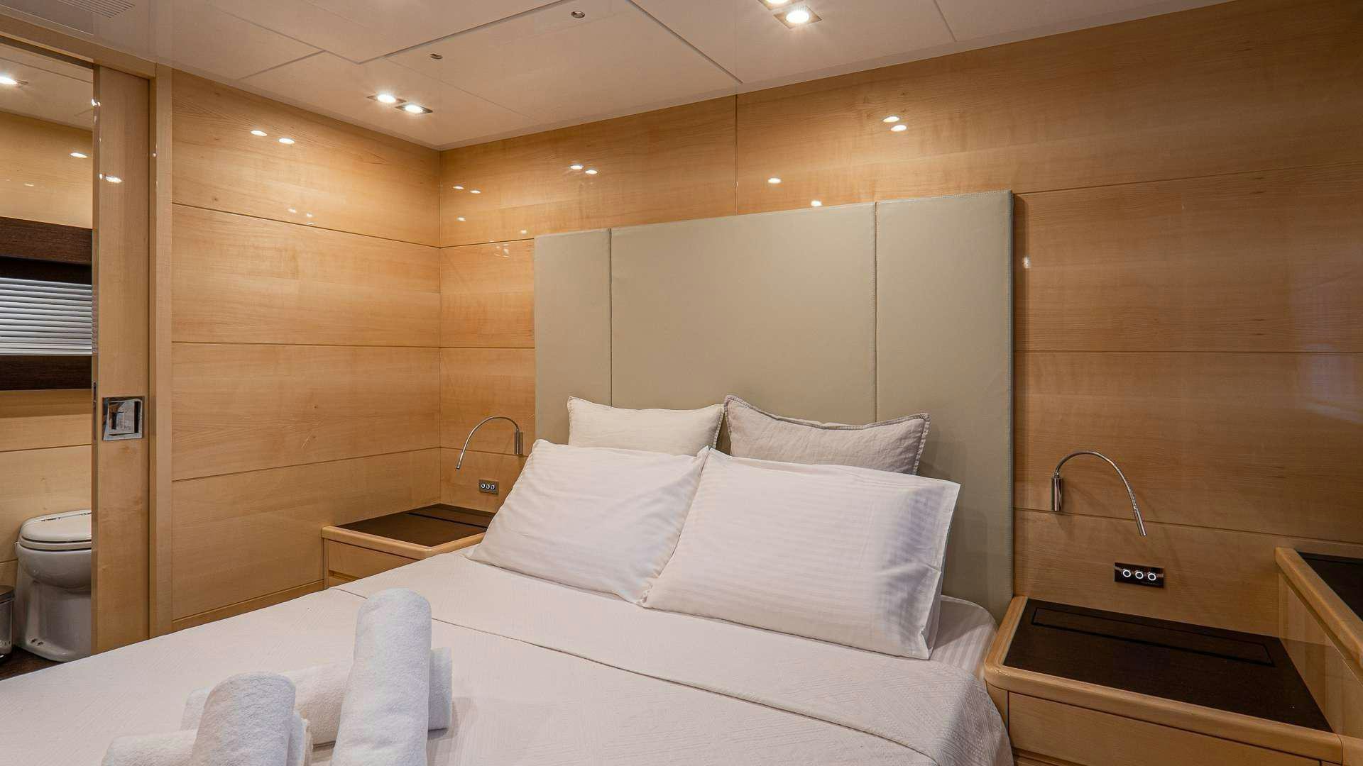 a room with a bed and a sink aboard LIBERATA Yacht for Charter