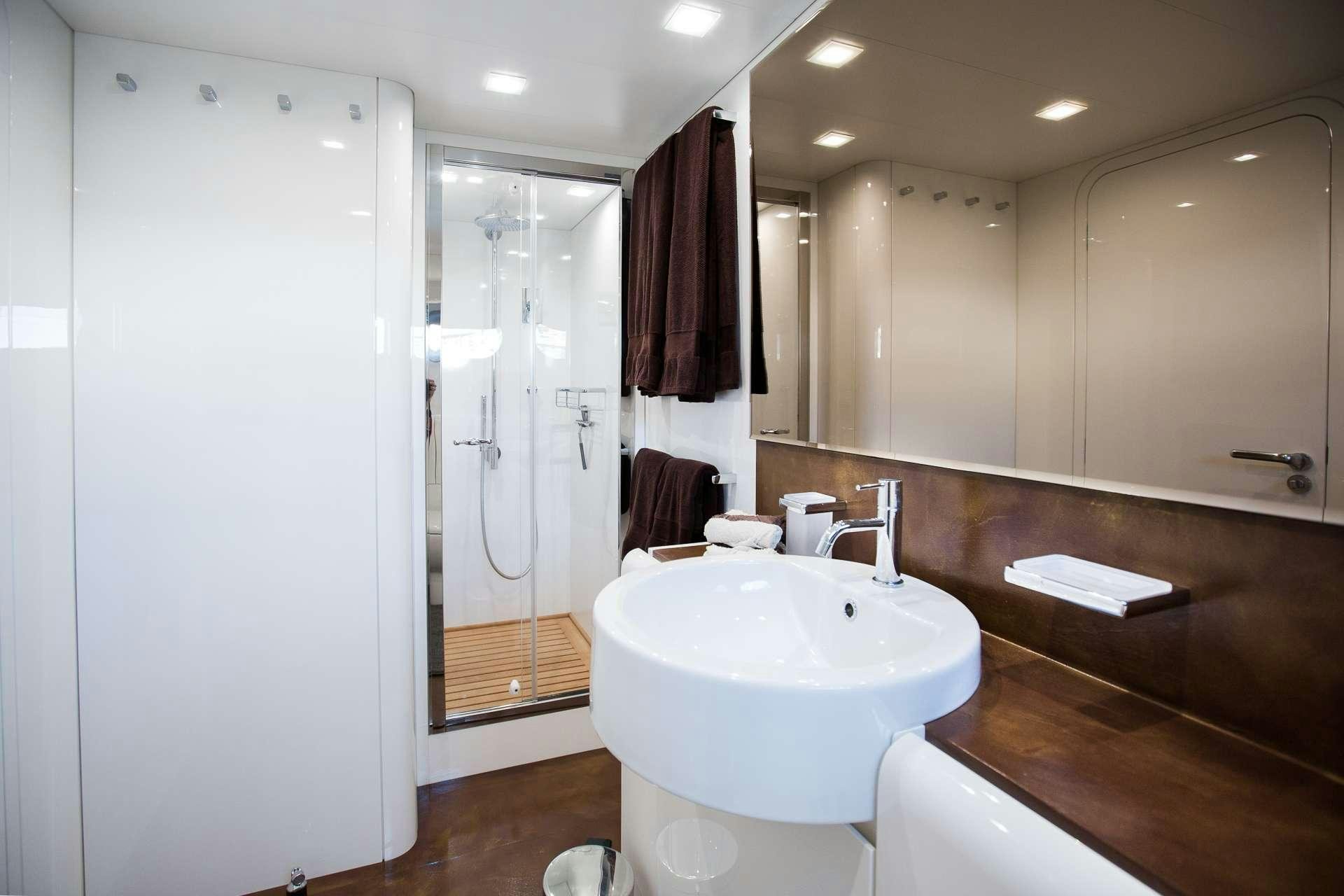 a bathroom with a sink and a shower aboard CAMILLA A Yacht for Charter