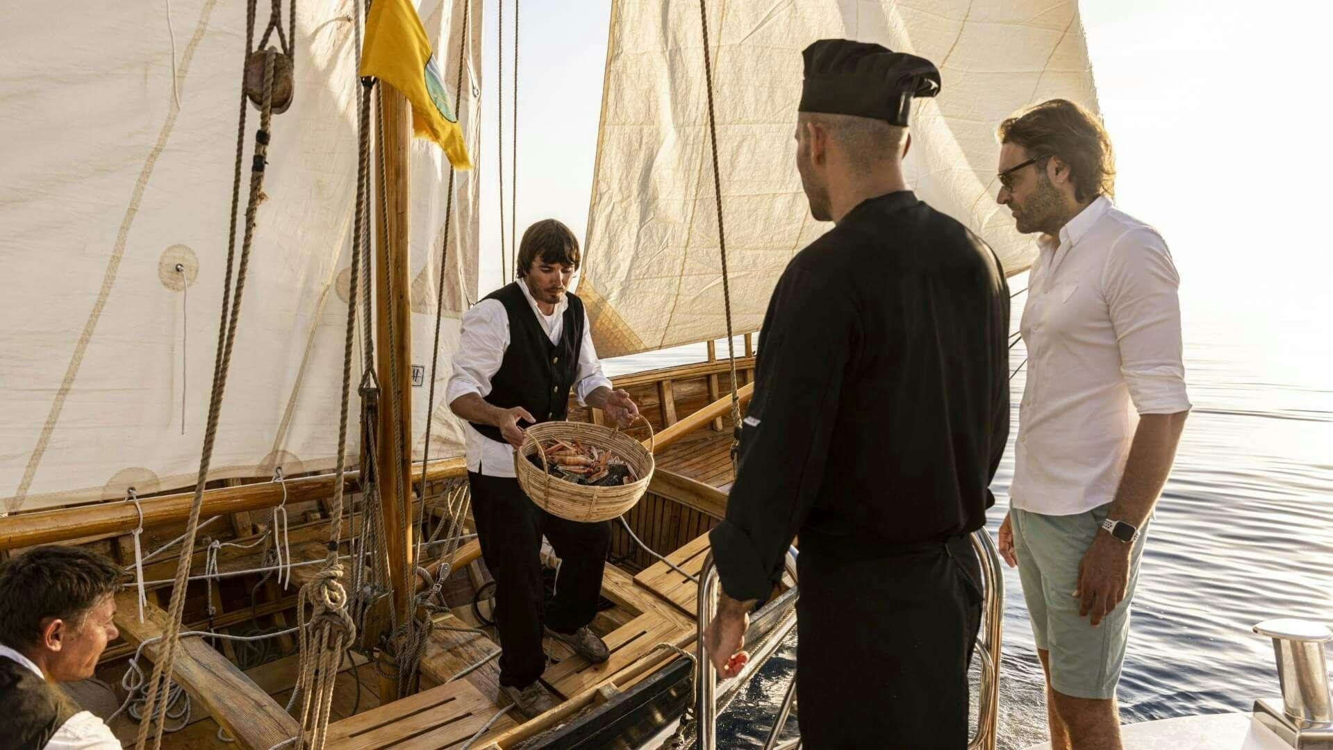 a group of people standing around a boat aboard M/Y ANTHEA Yacht for Charter