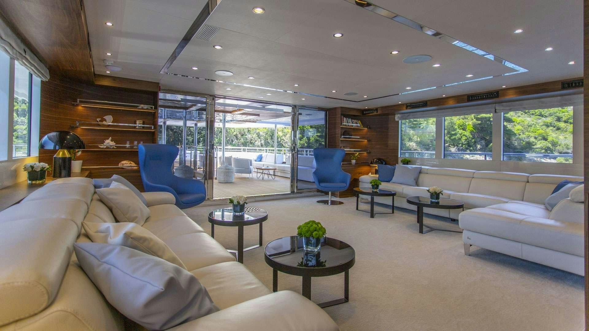a living room with a large window aboard M/Y ANTHEA Yacht for Charter