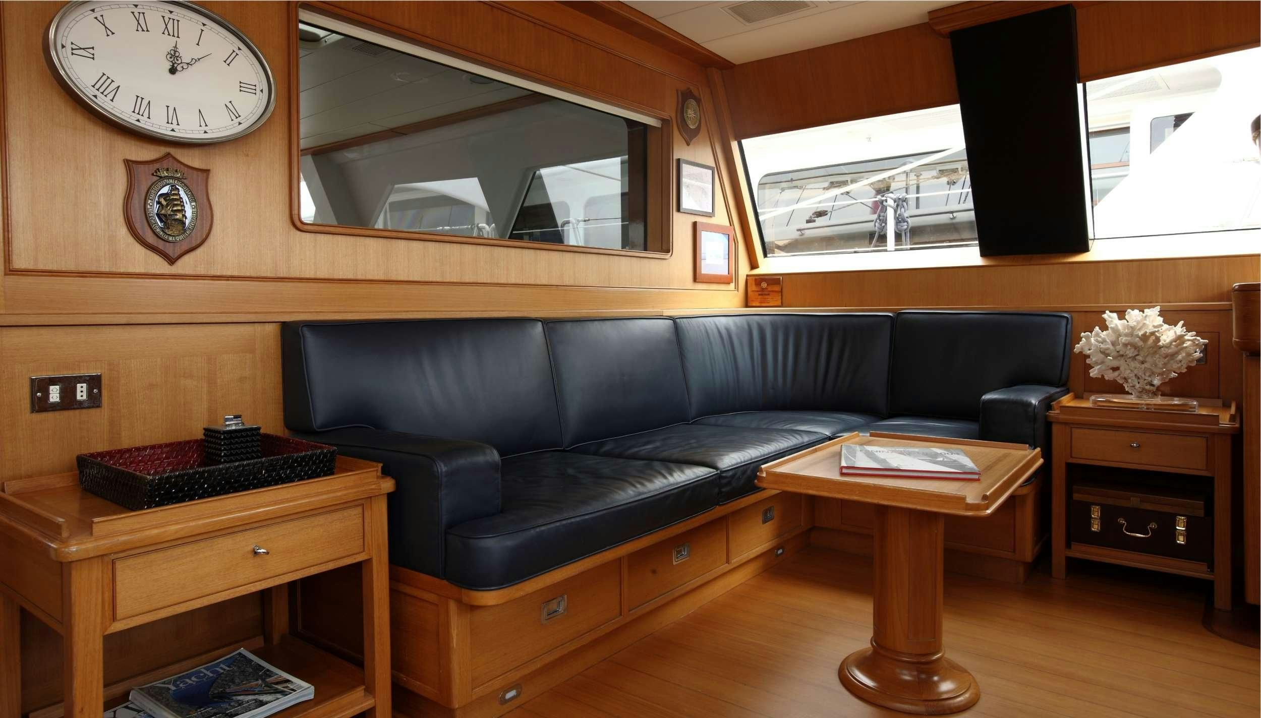 a living room with a couch and a coffee table aboard HERITAGE M Yacht for Charter