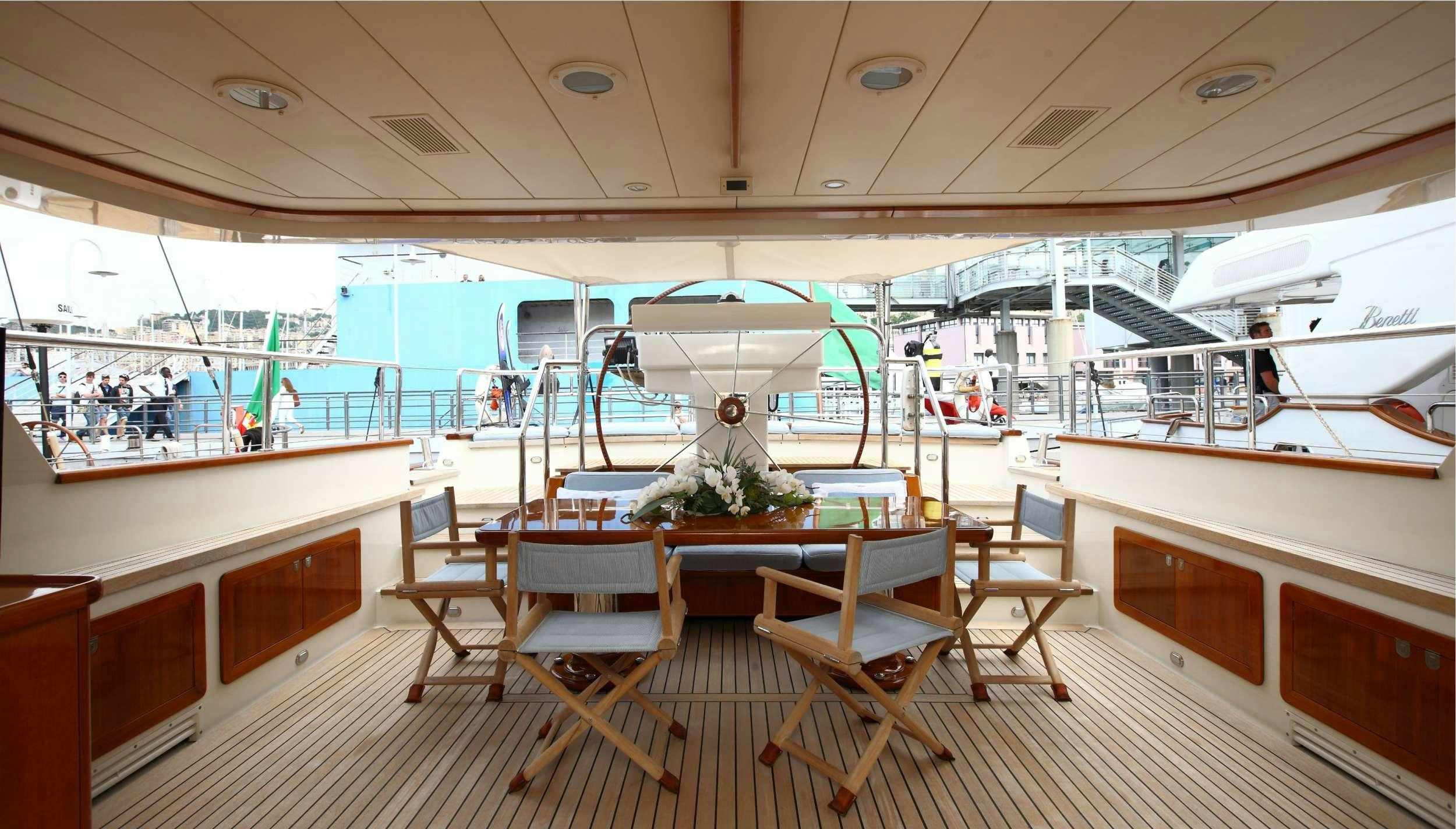 a room with tables and chairs aboard HERITAGE M Yacht for Charter