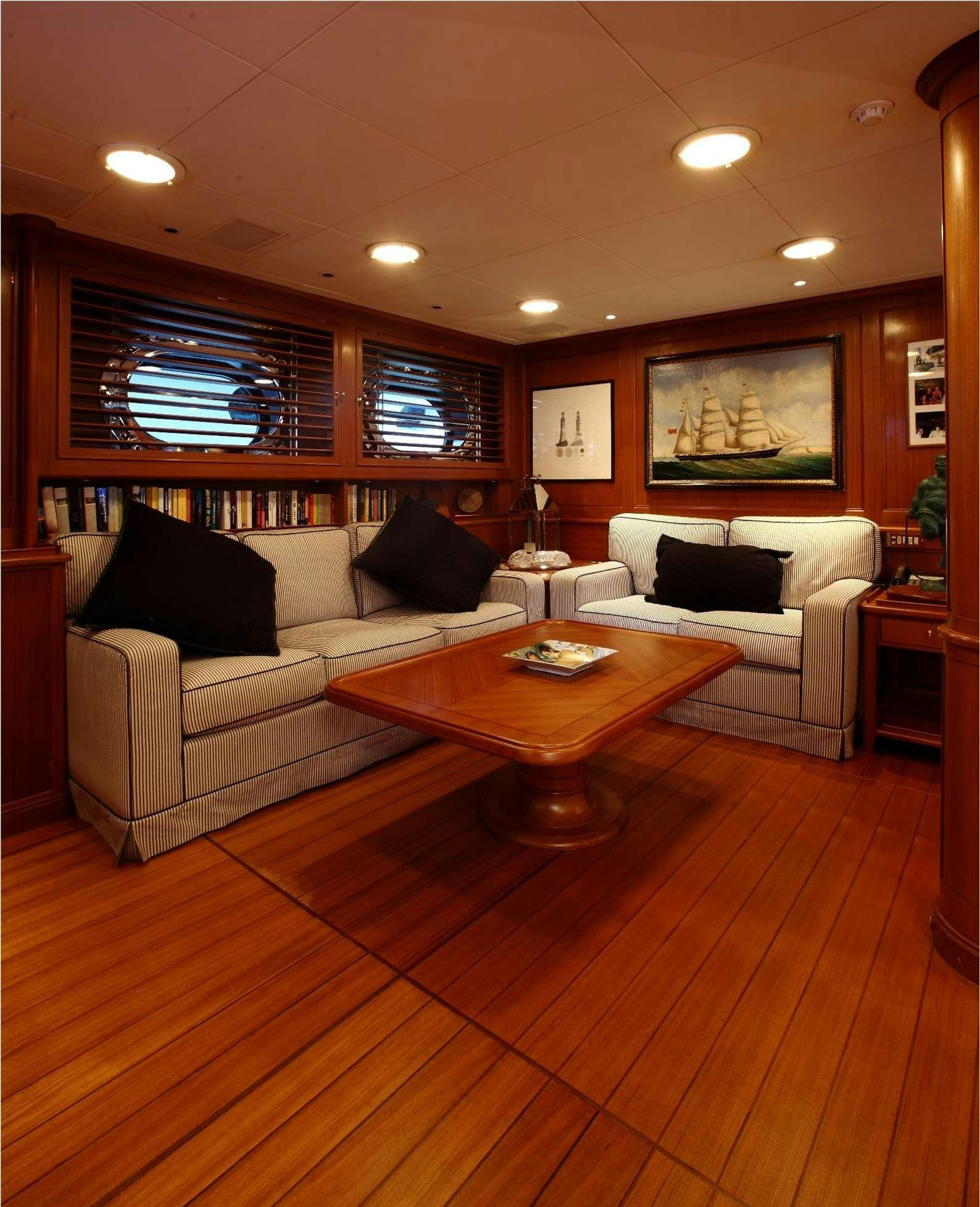 a living room with a couch and a coffee table aboard HERITAGE M Yacht for Charter