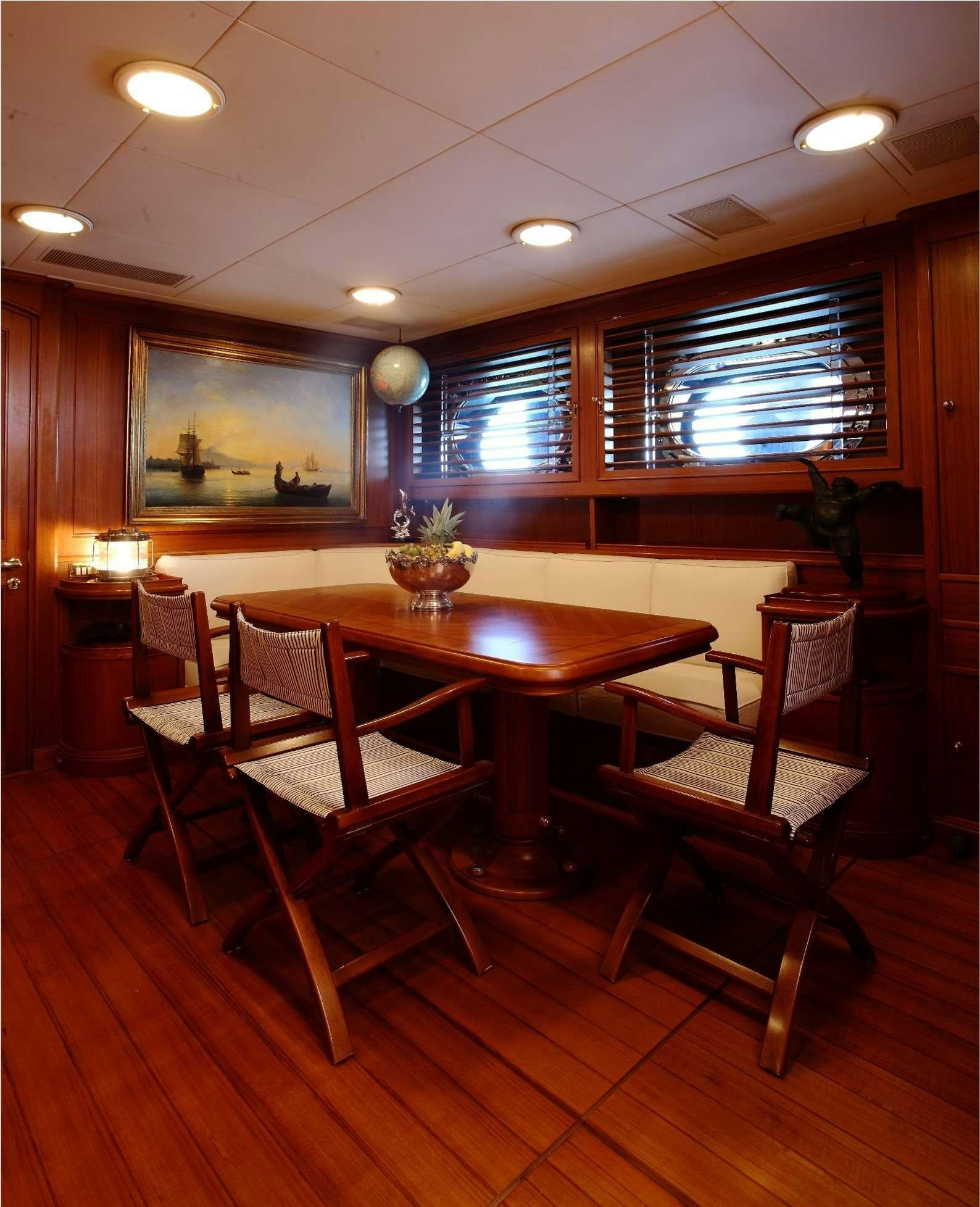 a room with a table and chairs aboard HERITAGE M Yacht for Charter