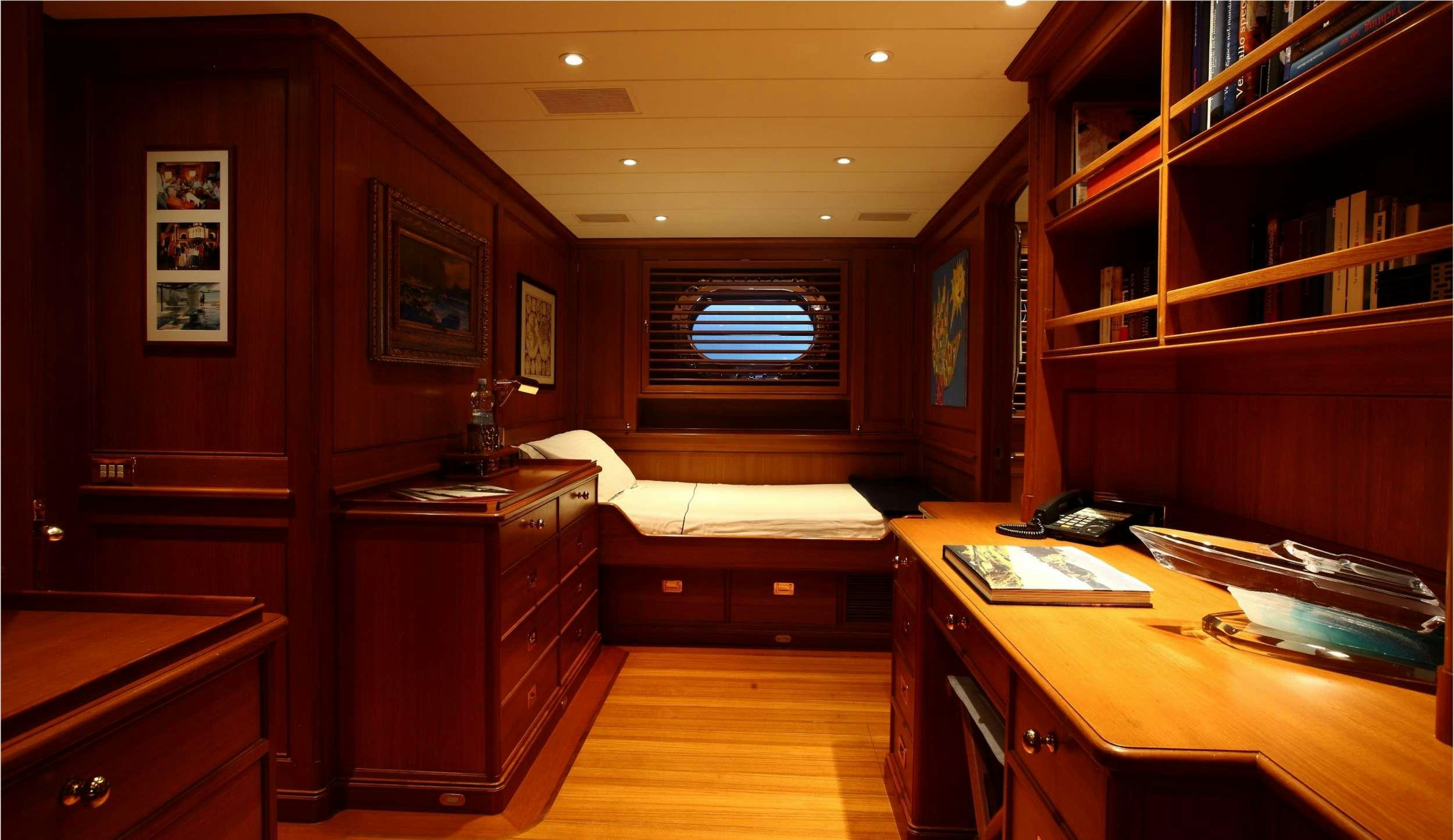 a room with a desk and a bed aboard HERITAGE M Yacht for Charter