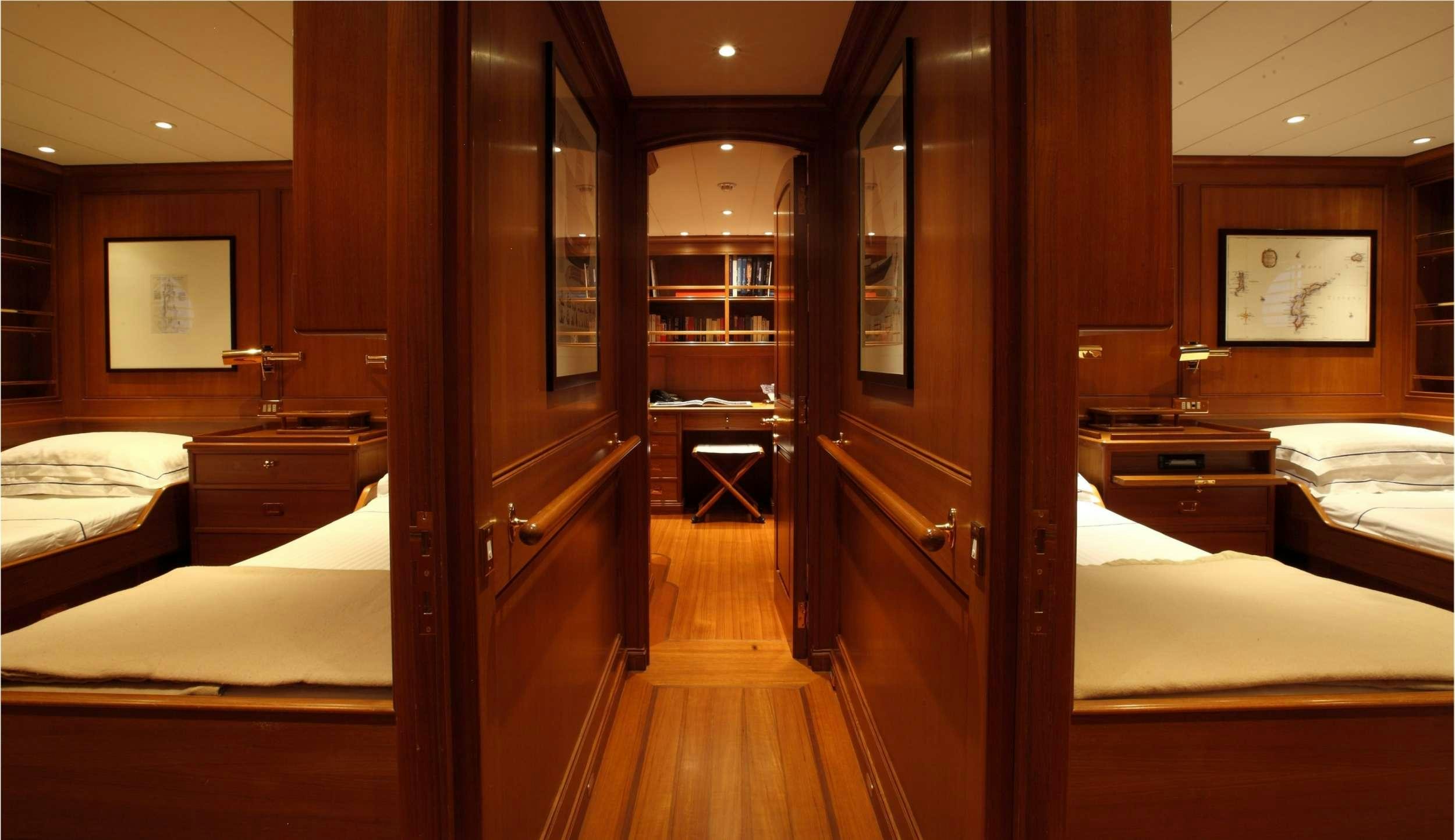 a room with a bed and a mirror aboard HERITAGE M Yacht for Charter