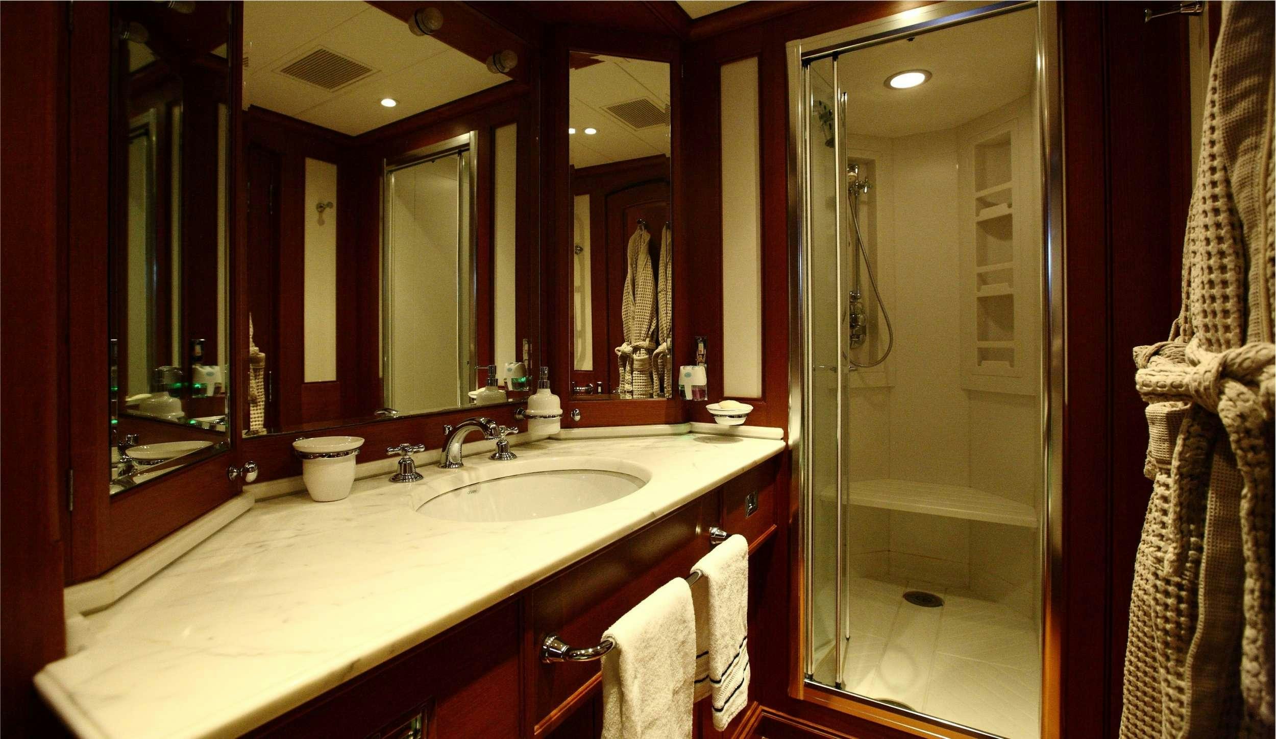 a bathroom with a large mirror aboard HERITAGE M Yacht for Charter