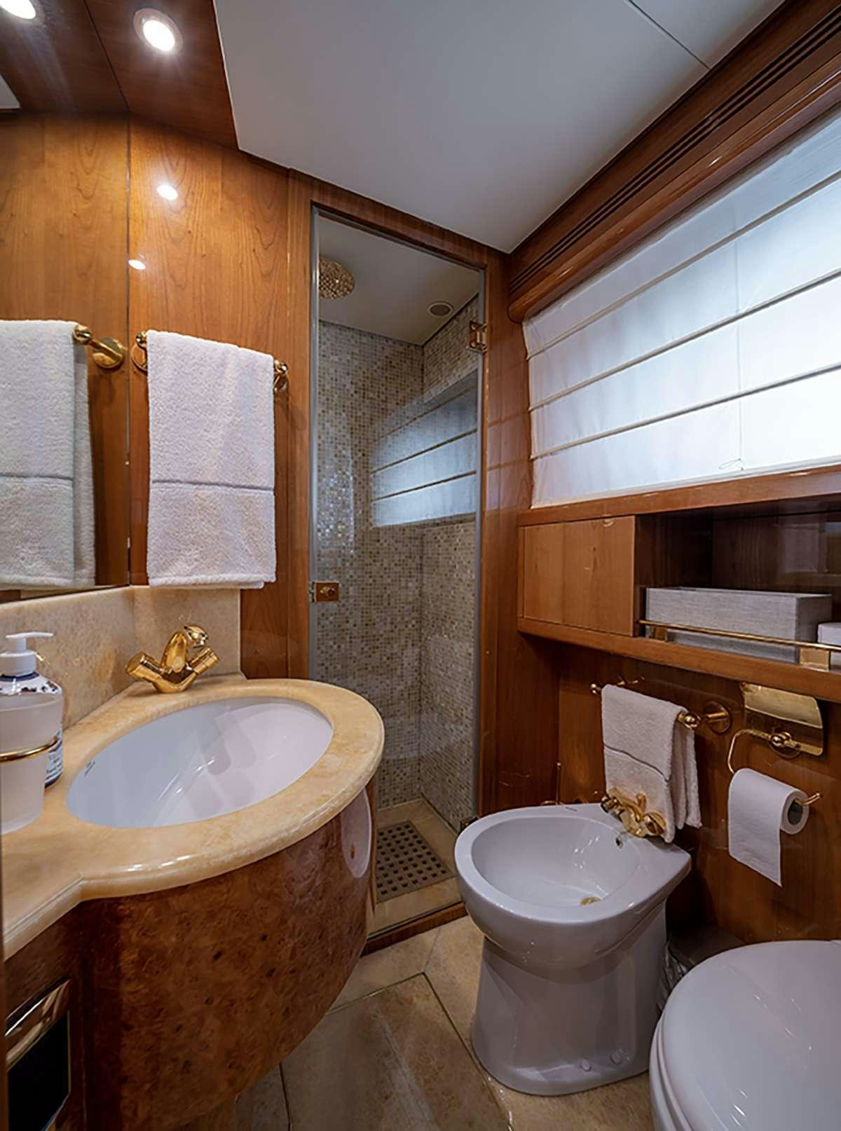 a bathroom with a sink toilet and a mirror aboard GOLDEN EAGLE Yacht for Charter