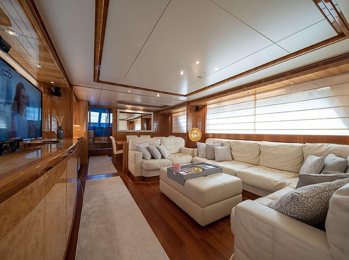 a living room with a large window aboard GOLDEN EAGLE Yacht for Charter