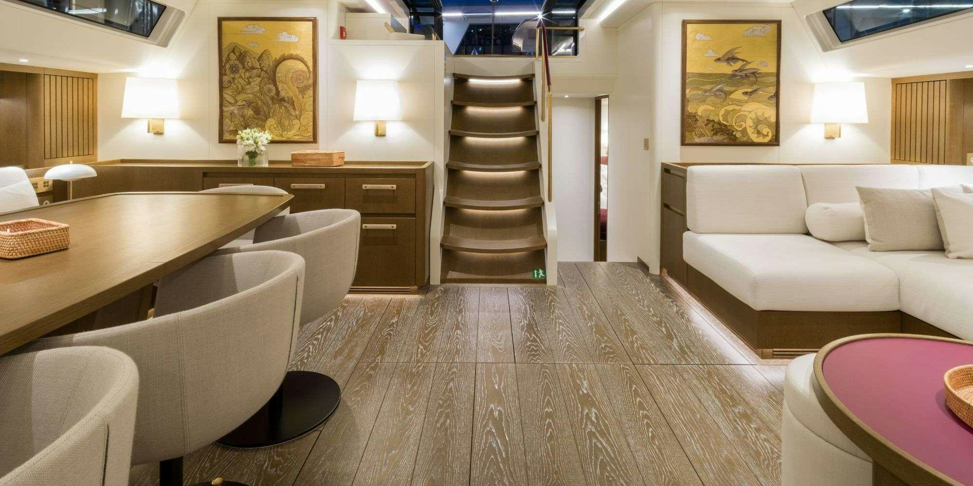 a living room with a staircase and a couch aboard FANCY Yacht for Charter