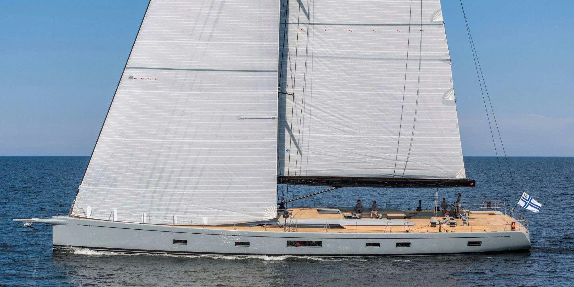 a large white boat with a large sail aboard FANCY Yacht for Charter