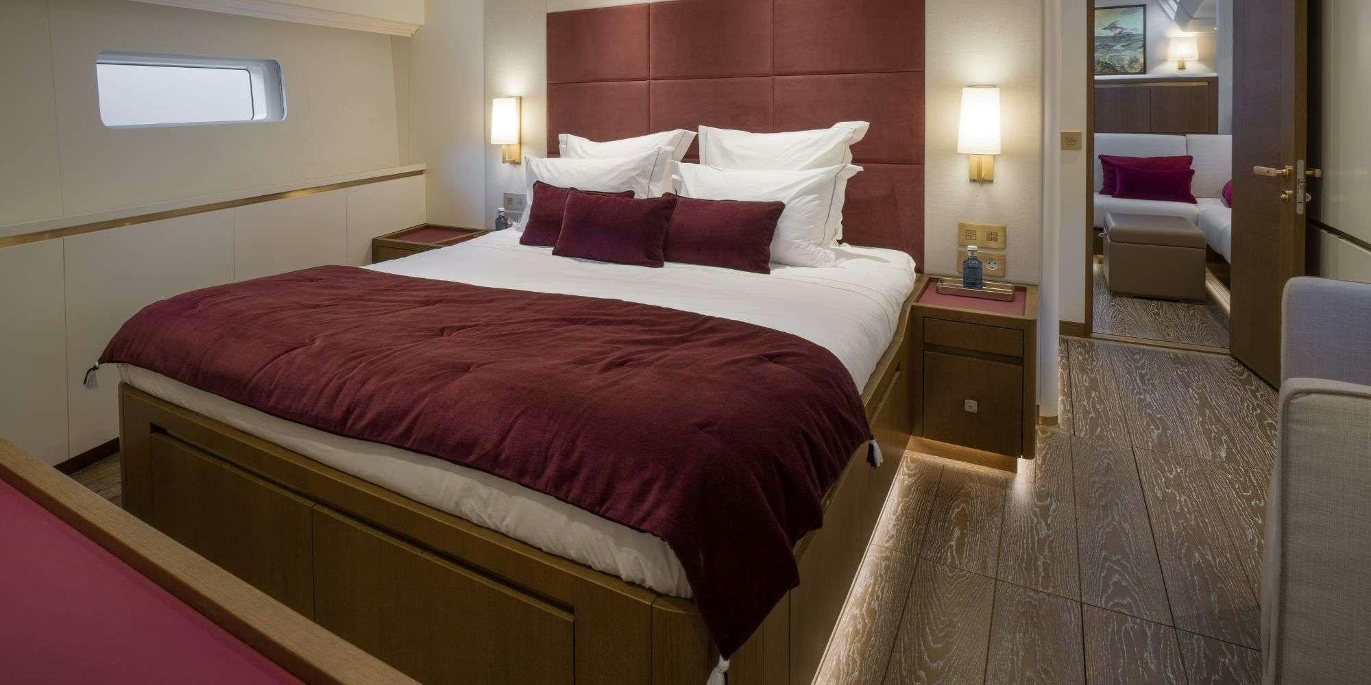 a hotel room with a bed and a desk aboard FANCY Yacht for Charter