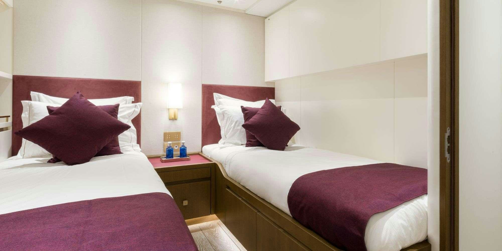 a couple of beds in a hotel room aboard FANCY Yacht for Charter