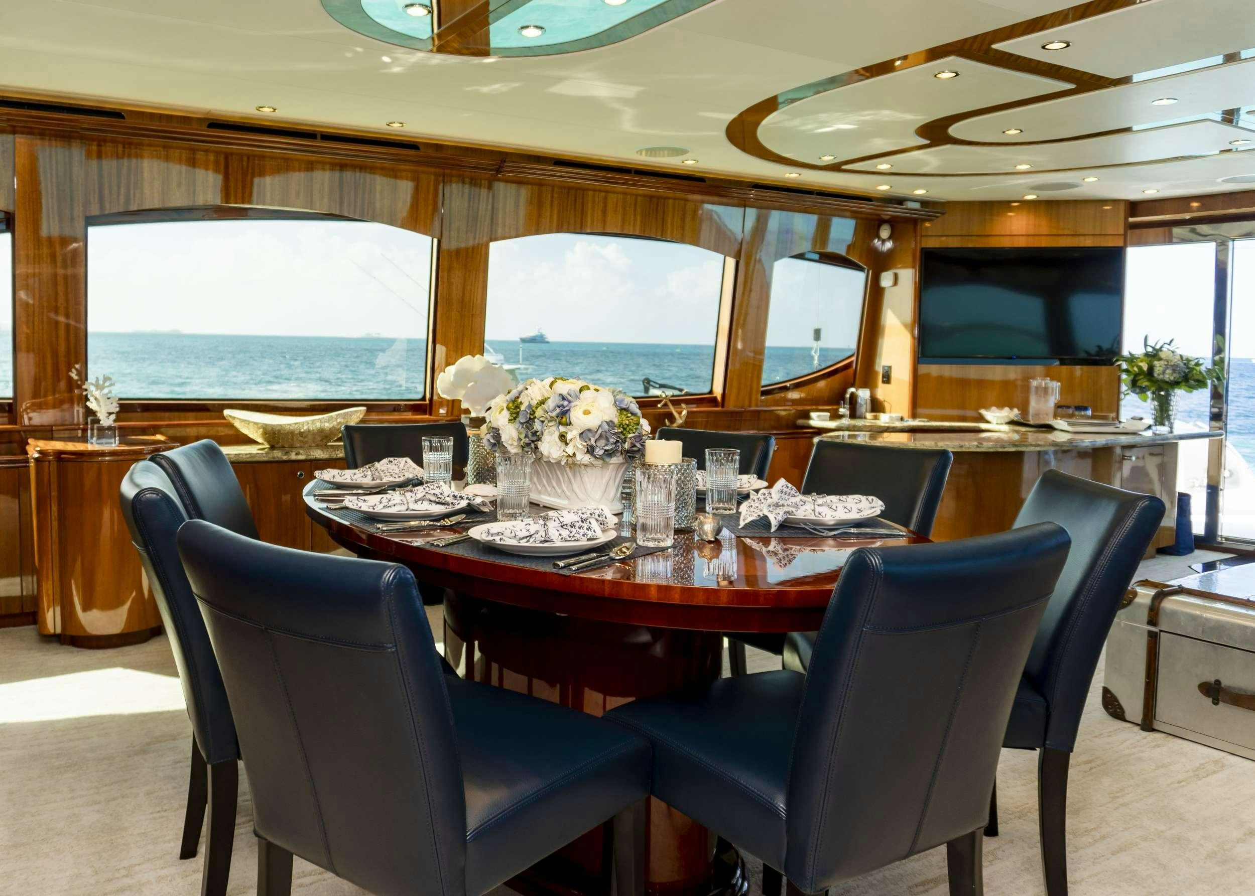 a dining room with a large table aboard GAIL FORCE II Yacht for Charter