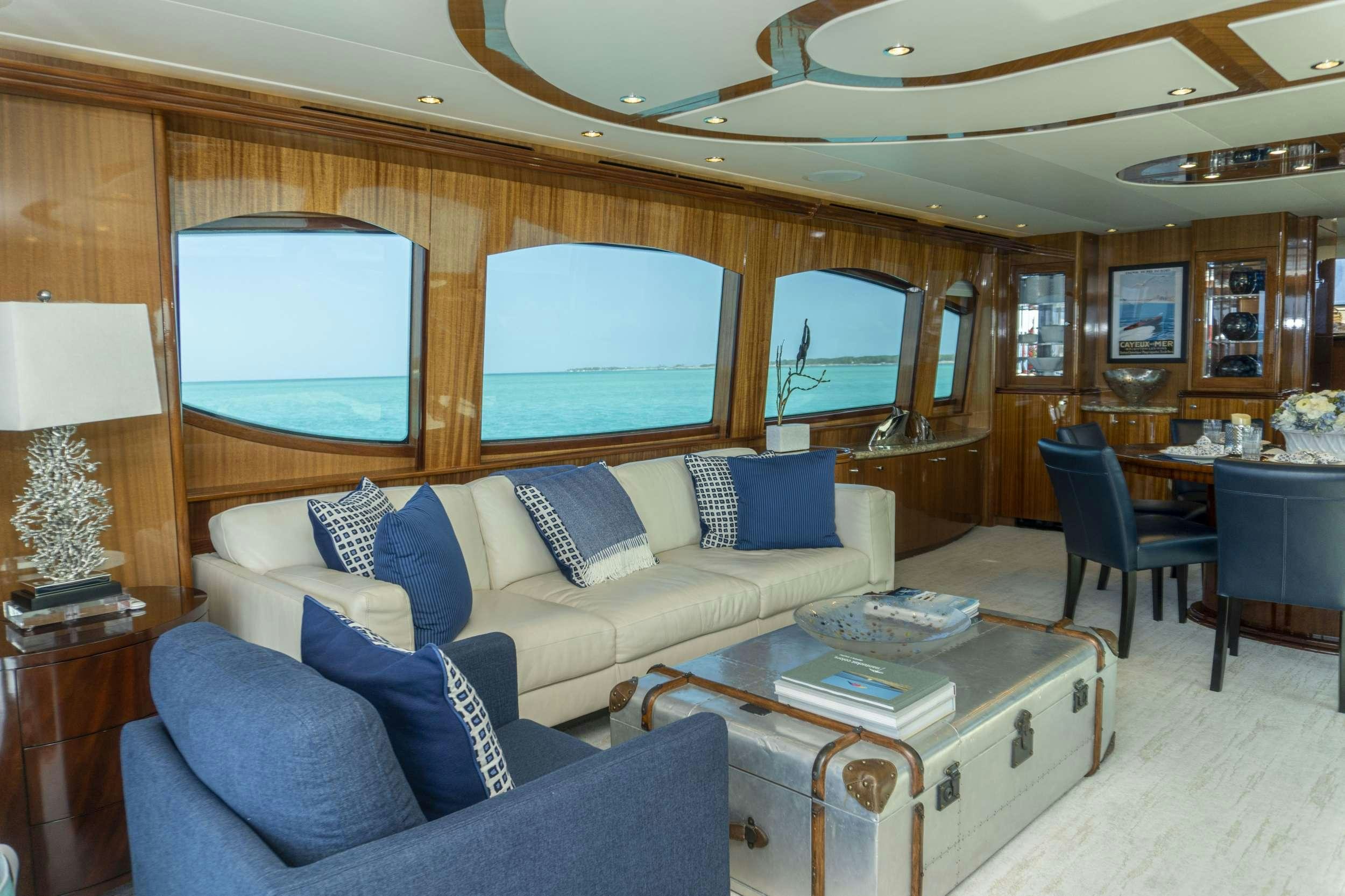 a living room with a couch and a table aboard GAIL FORCE II Yacht for Charter