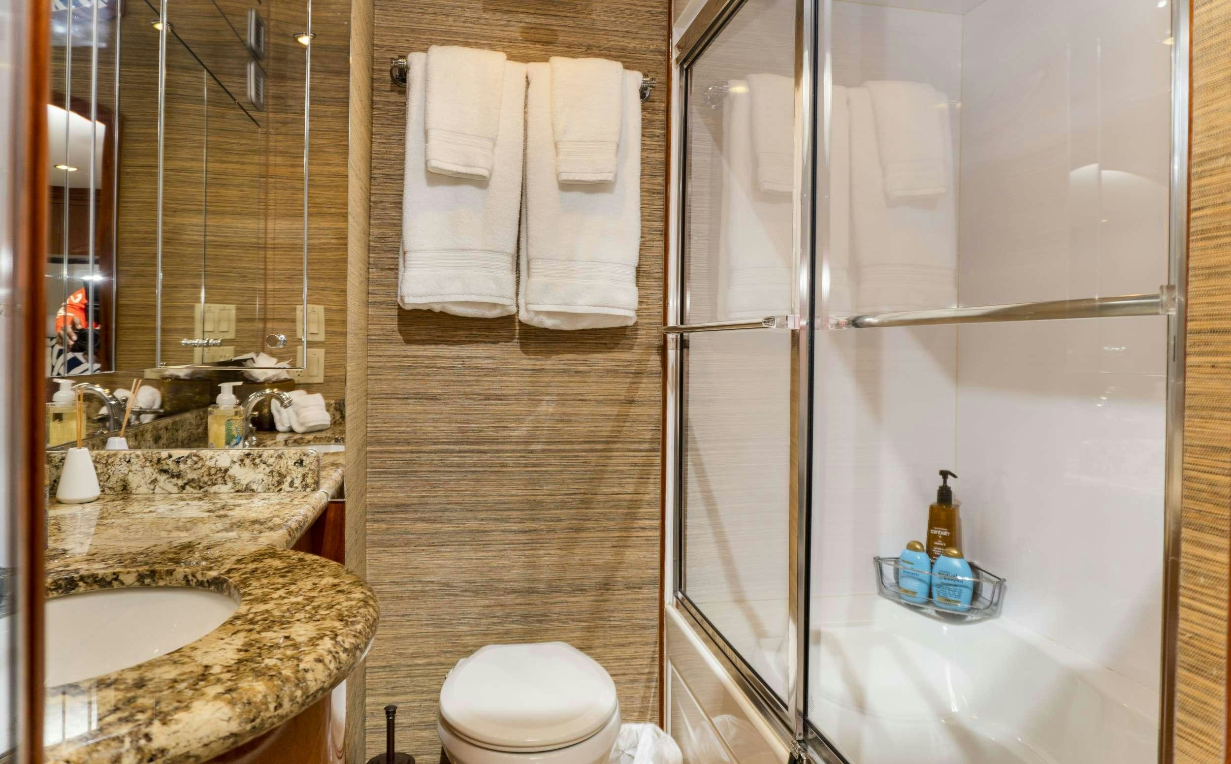a bathroom with a shower and sink aboard GAIL FORCE II Yacht for Charter