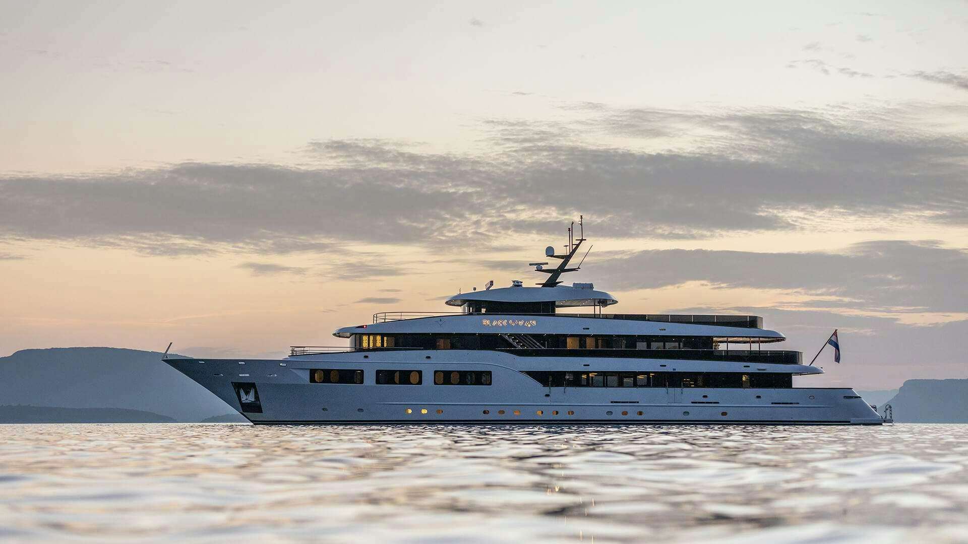 a large ship in the water aboard BLACK SWAN Yacht for Charter