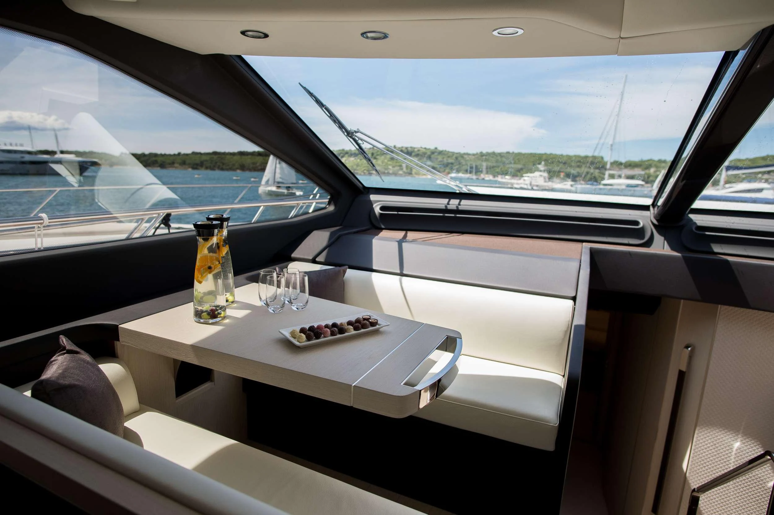 a table with a glass of water on it aboard ALYSS Yacht for Charter