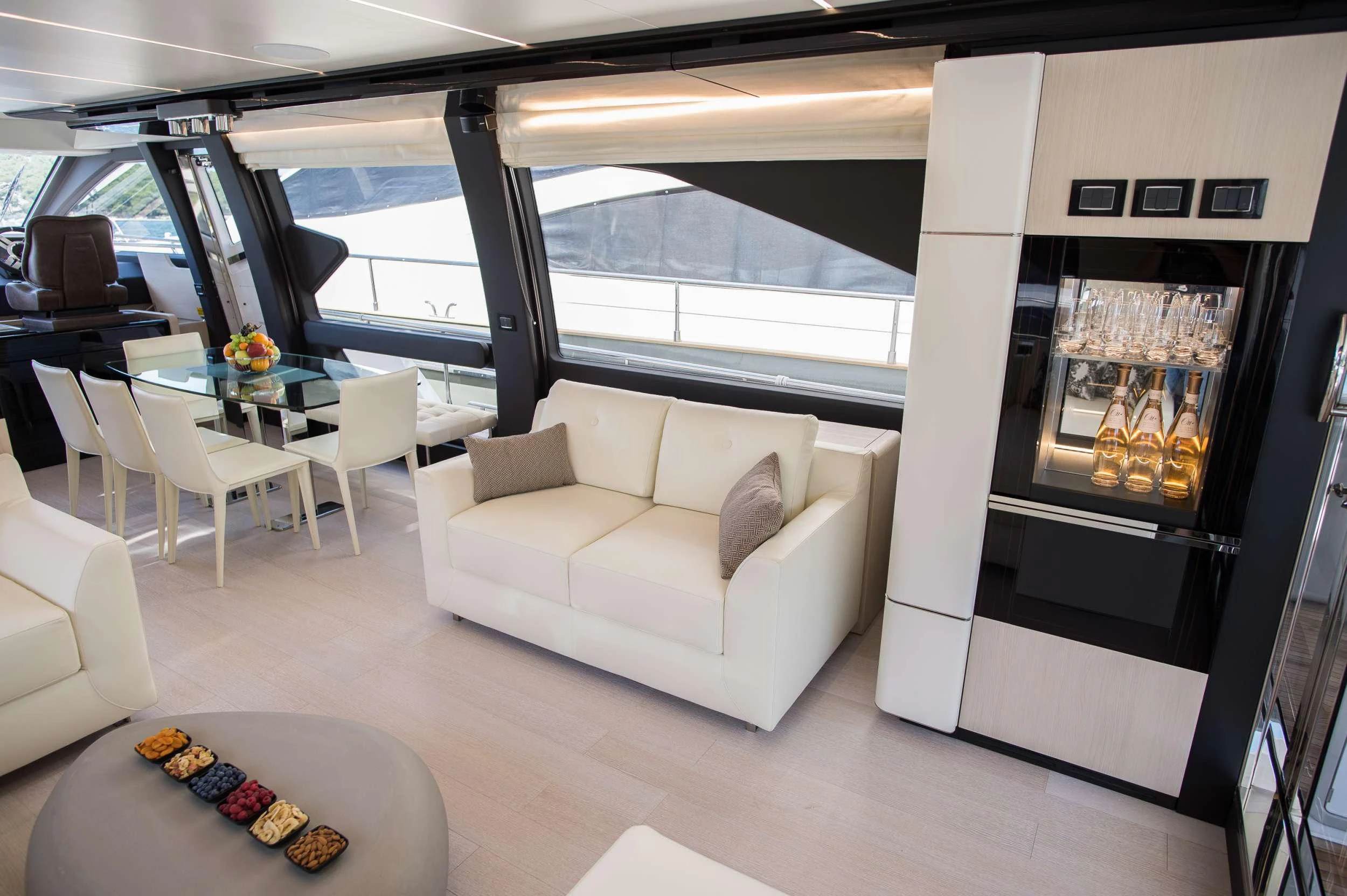 a room with a couch and a table and chairs aboard ALYSS Yacht for Charter