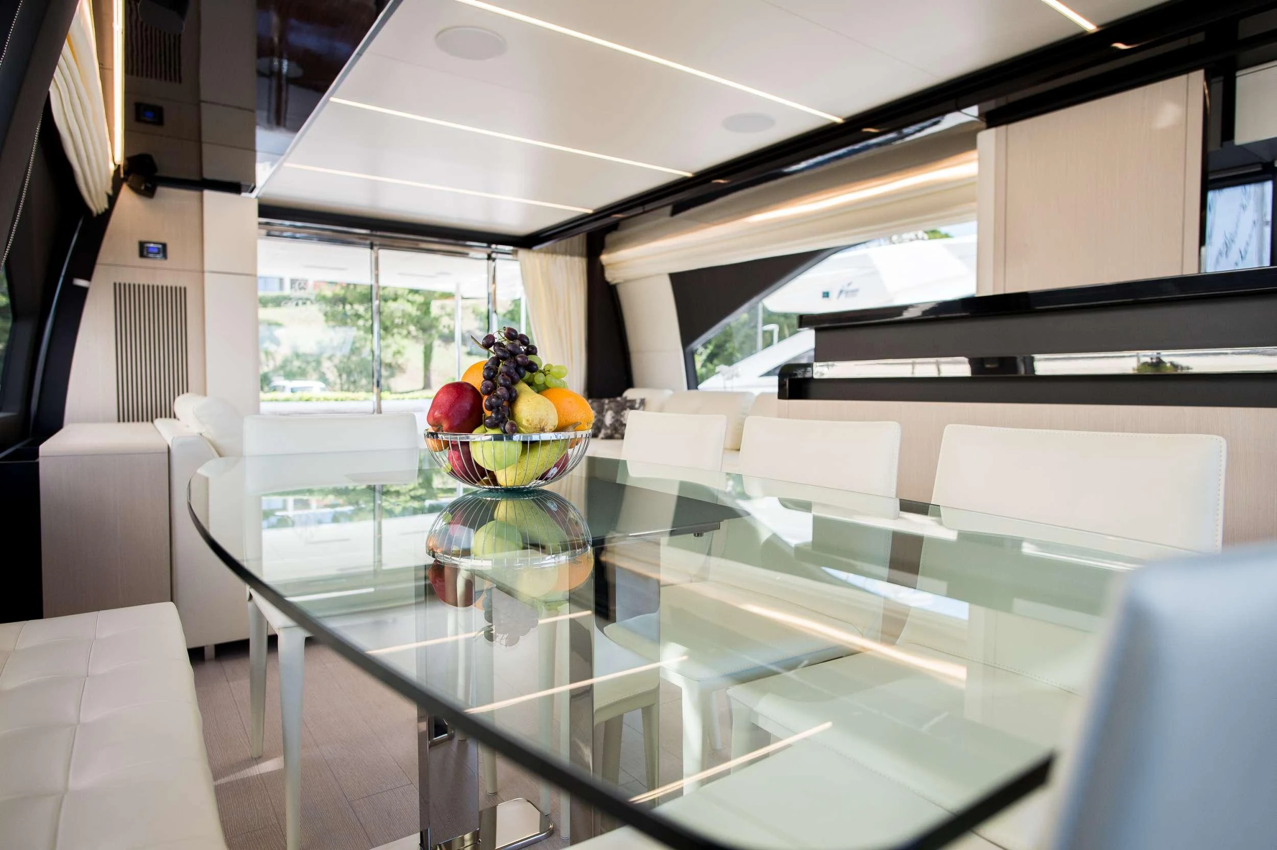 a glass table with fruit on it aboard ALYSS Yacht for Charter