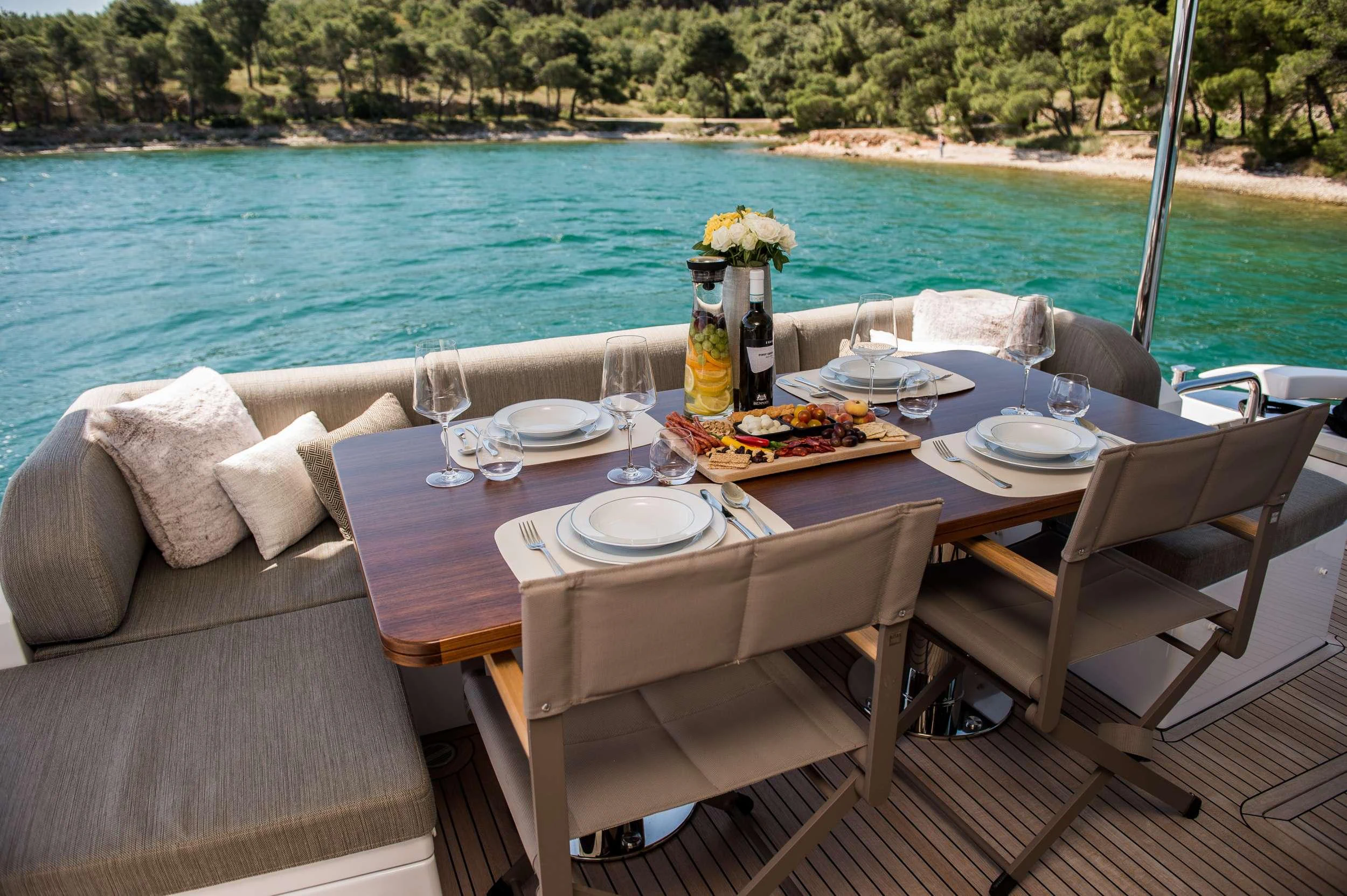 a table set for a meal on a beach aboard ALYSS Yacht for Charter