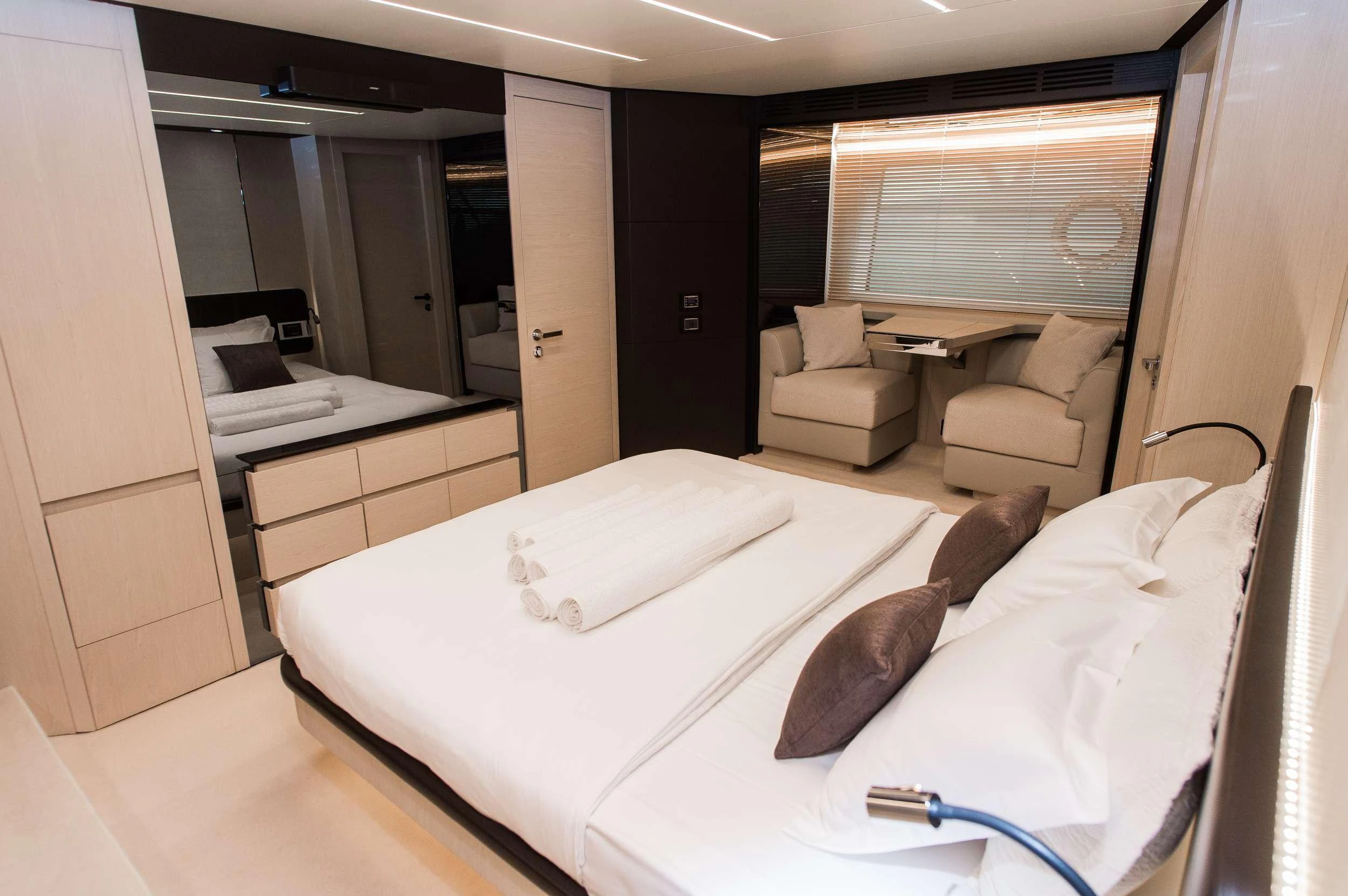 a room with a bed and a couch aboard ALYSS Yacht for Charter
