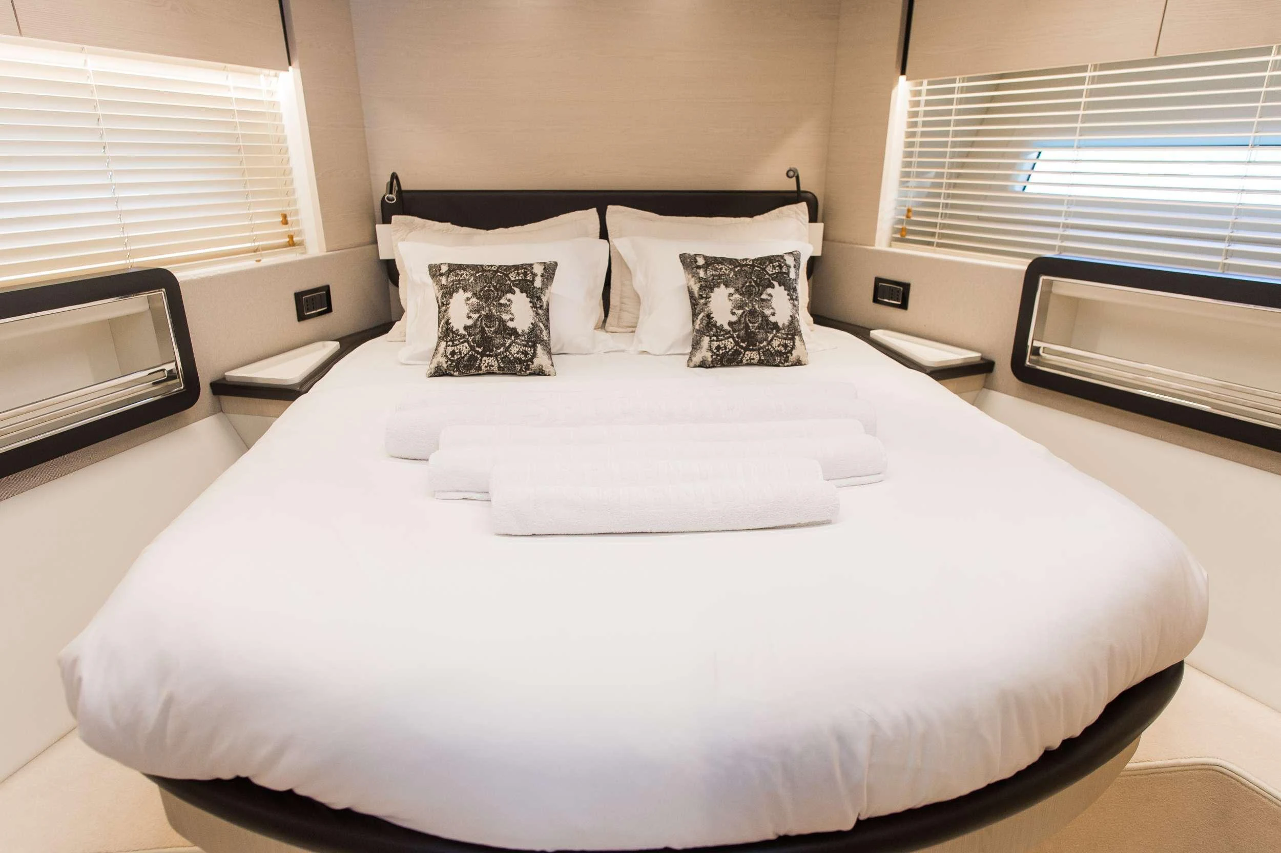 a bed with white sheets aboard ALYSS Yacht for Charter