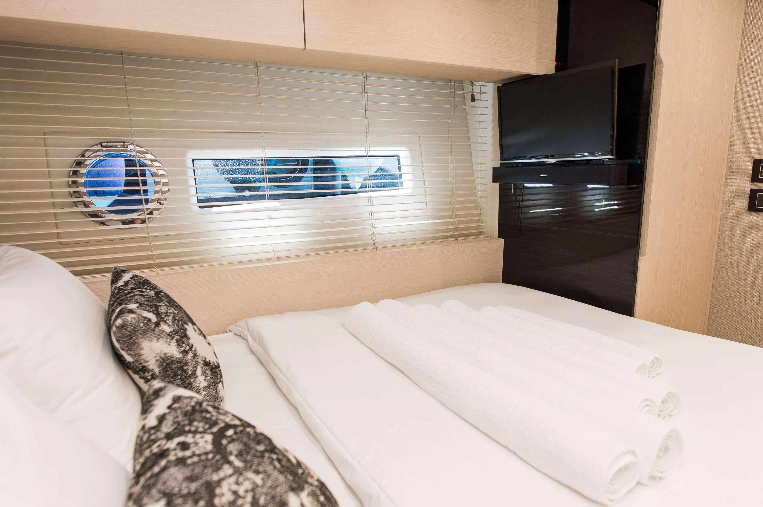 a bed with a white pillow aboard ALYSS Yacht for Charter