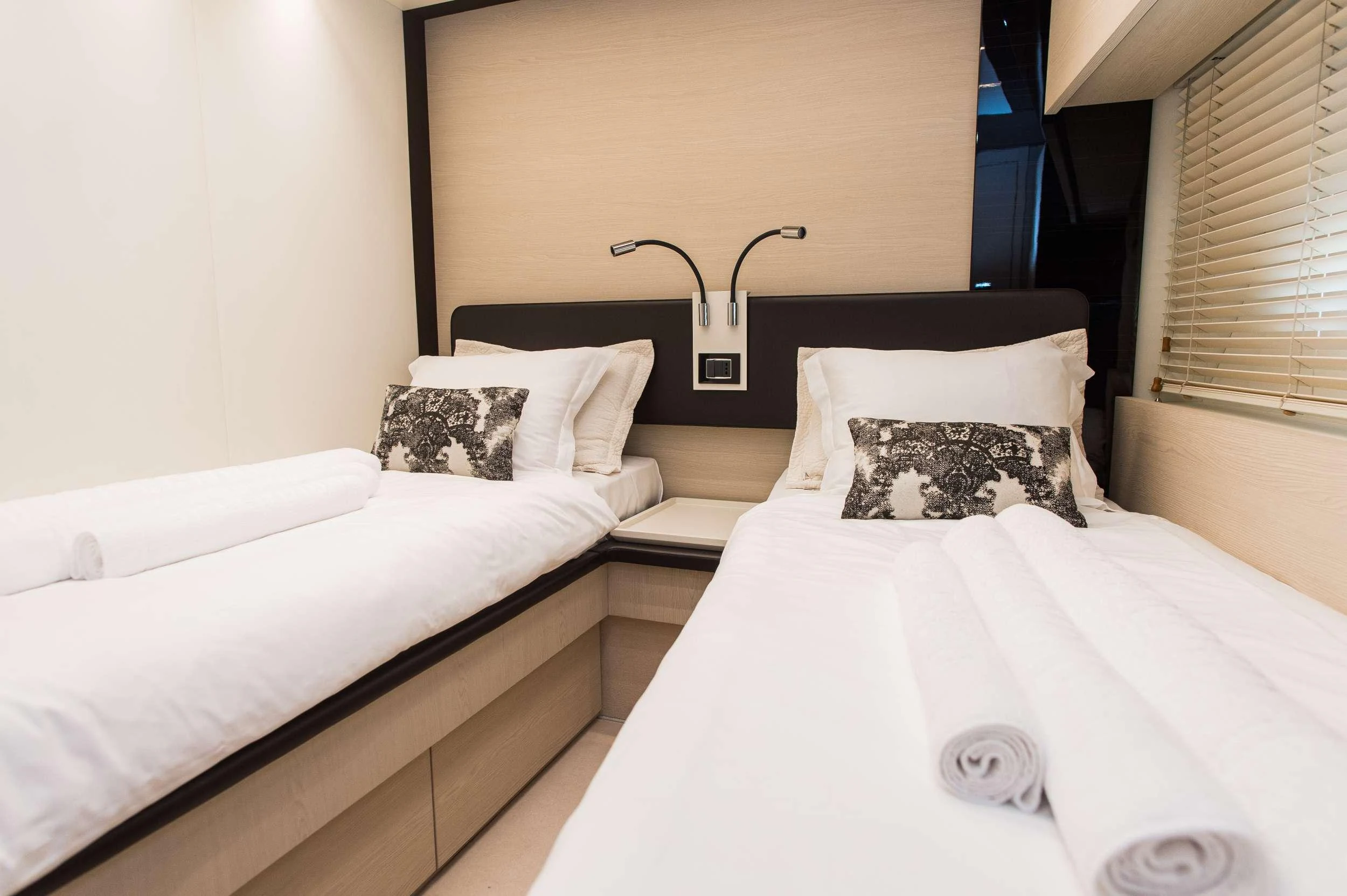 a couple of beds in a room aboard ALYSS Yacht for Charter