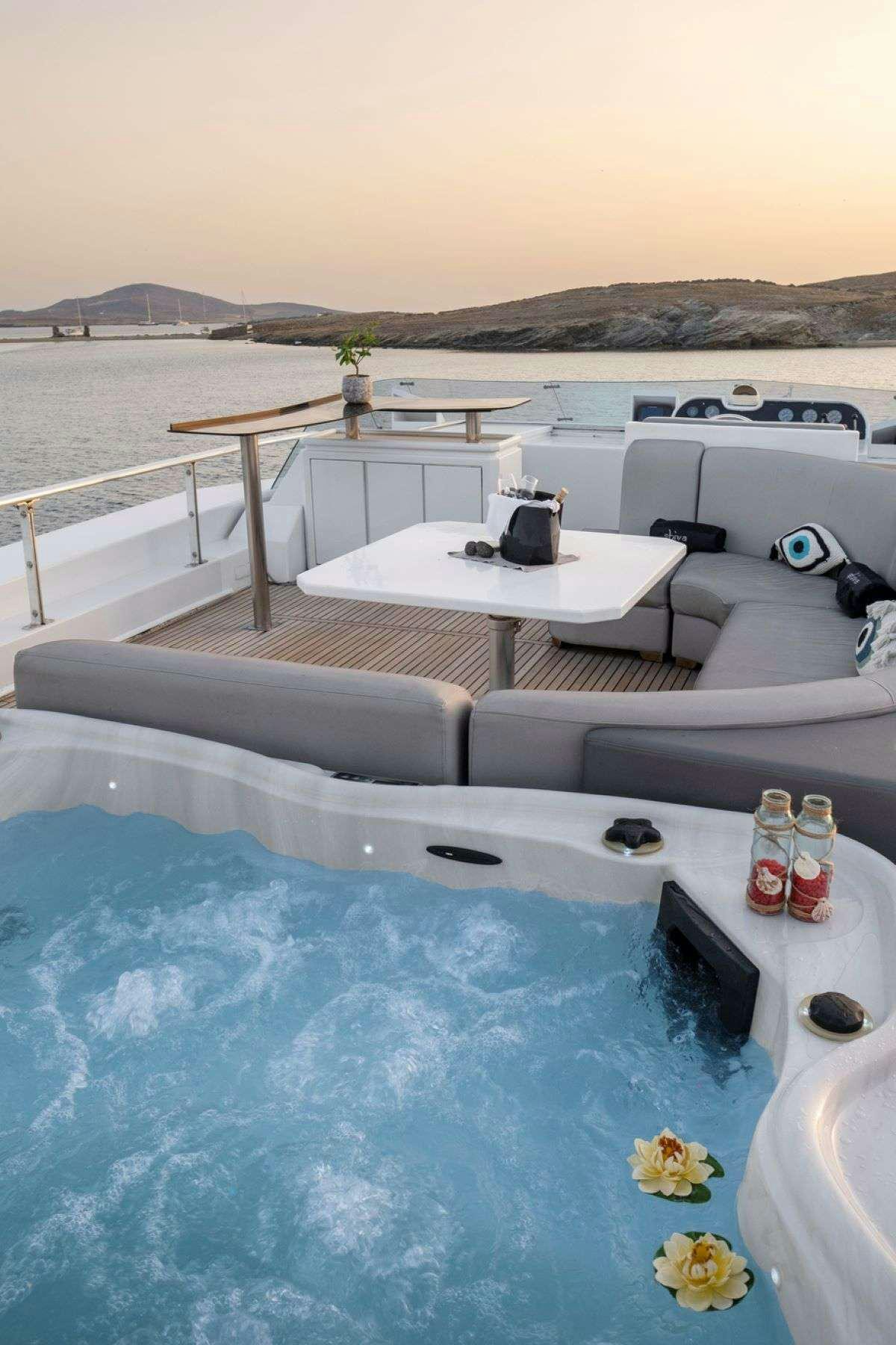a pool with a table and chairs aboard SHIVA Yacht for Charter