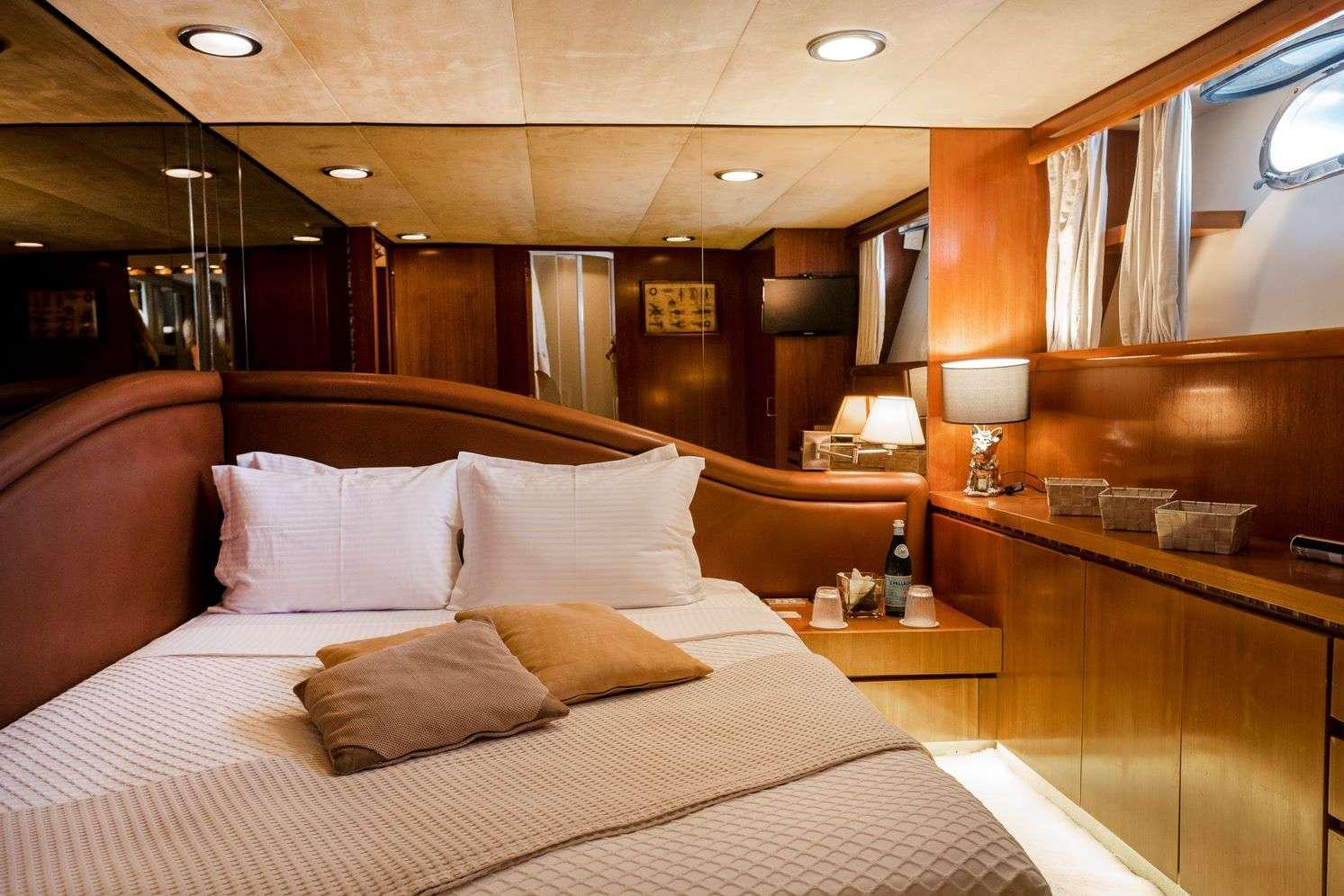 a bed with pillows aboard SHIVA Yacht for Charter